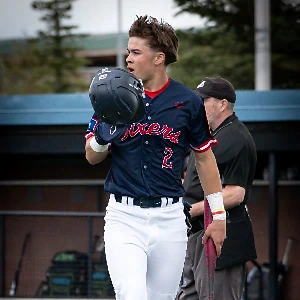 Youth baseball player walking off the field, representing Lumen Athletics sports performance in Cheyenne, WY.