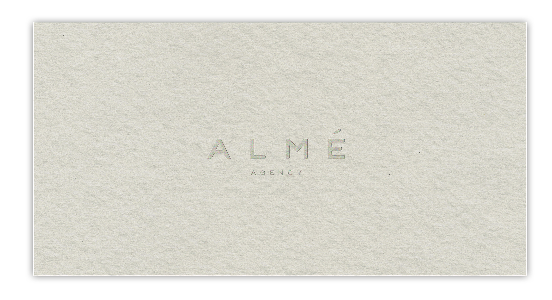 ALMÉ Agency business card on textured paper