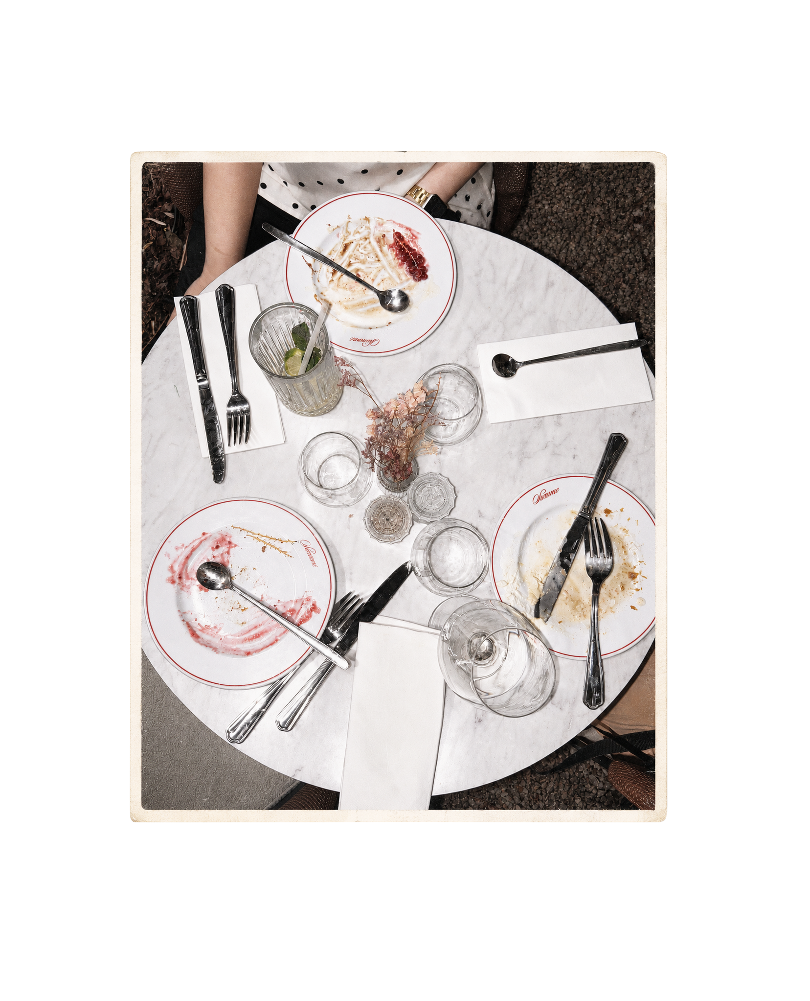 Overhead view of a marble café table after a shared lunch