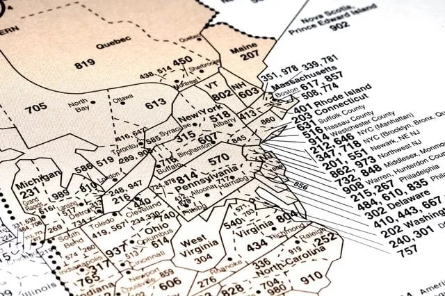 Close-up map of northeastern US states and southeastern Canada showing area codes with city and county names such as Massachusetts, New York, Pennsylvania, Ohio, and Ontario.
