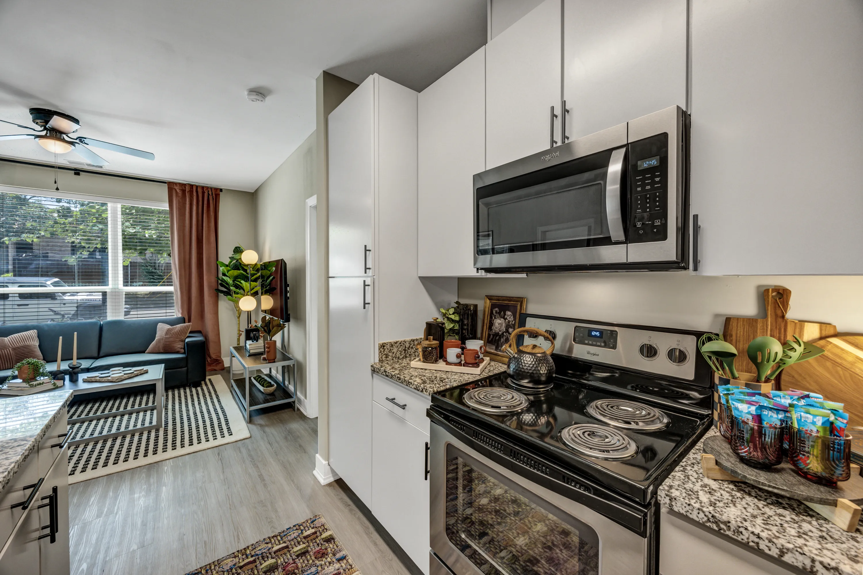 Kitchen stove and microwave beside the living room at The Den Student Living
