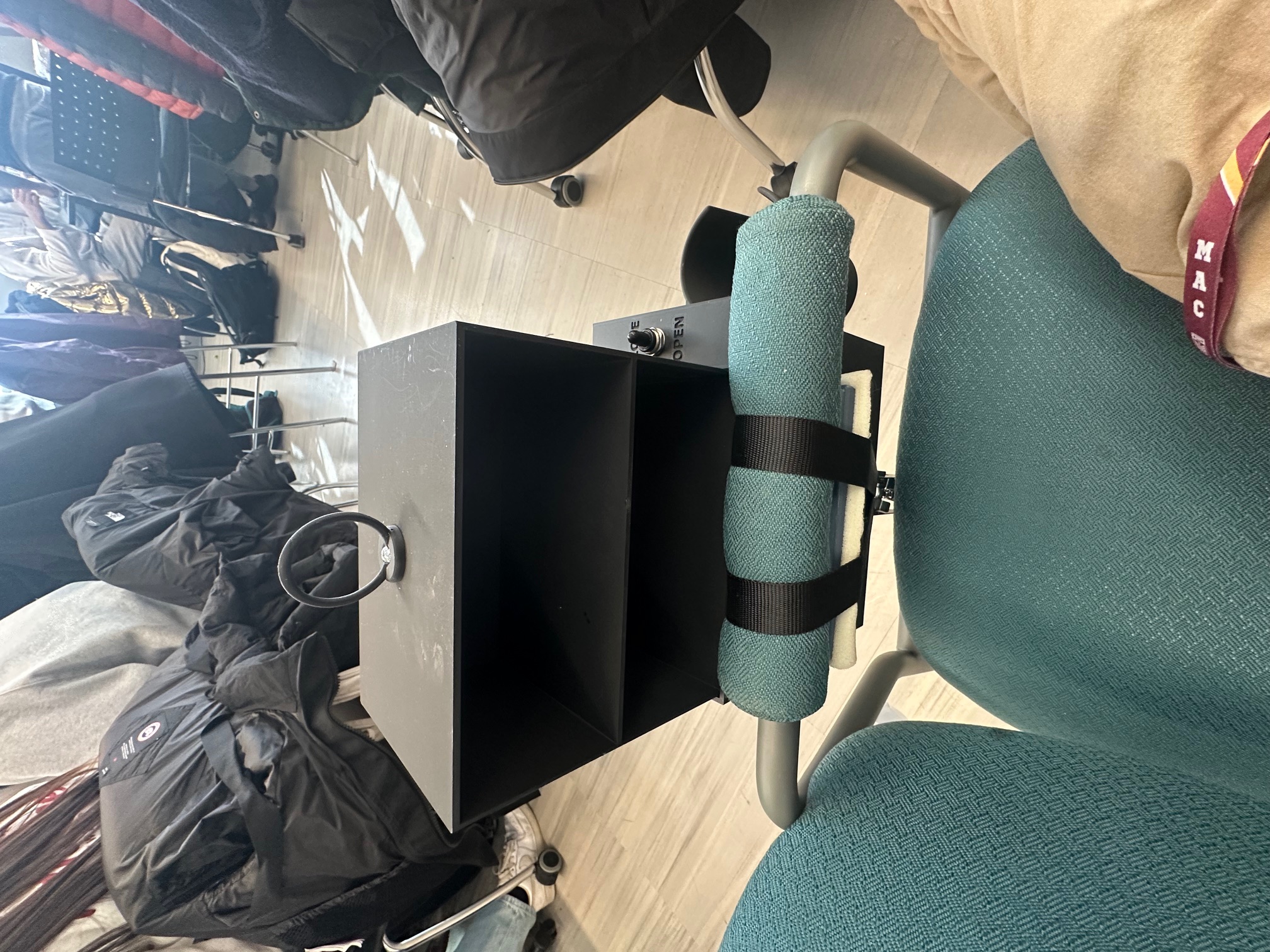 Lift Locker mounted to a chair armrest with the shelf open