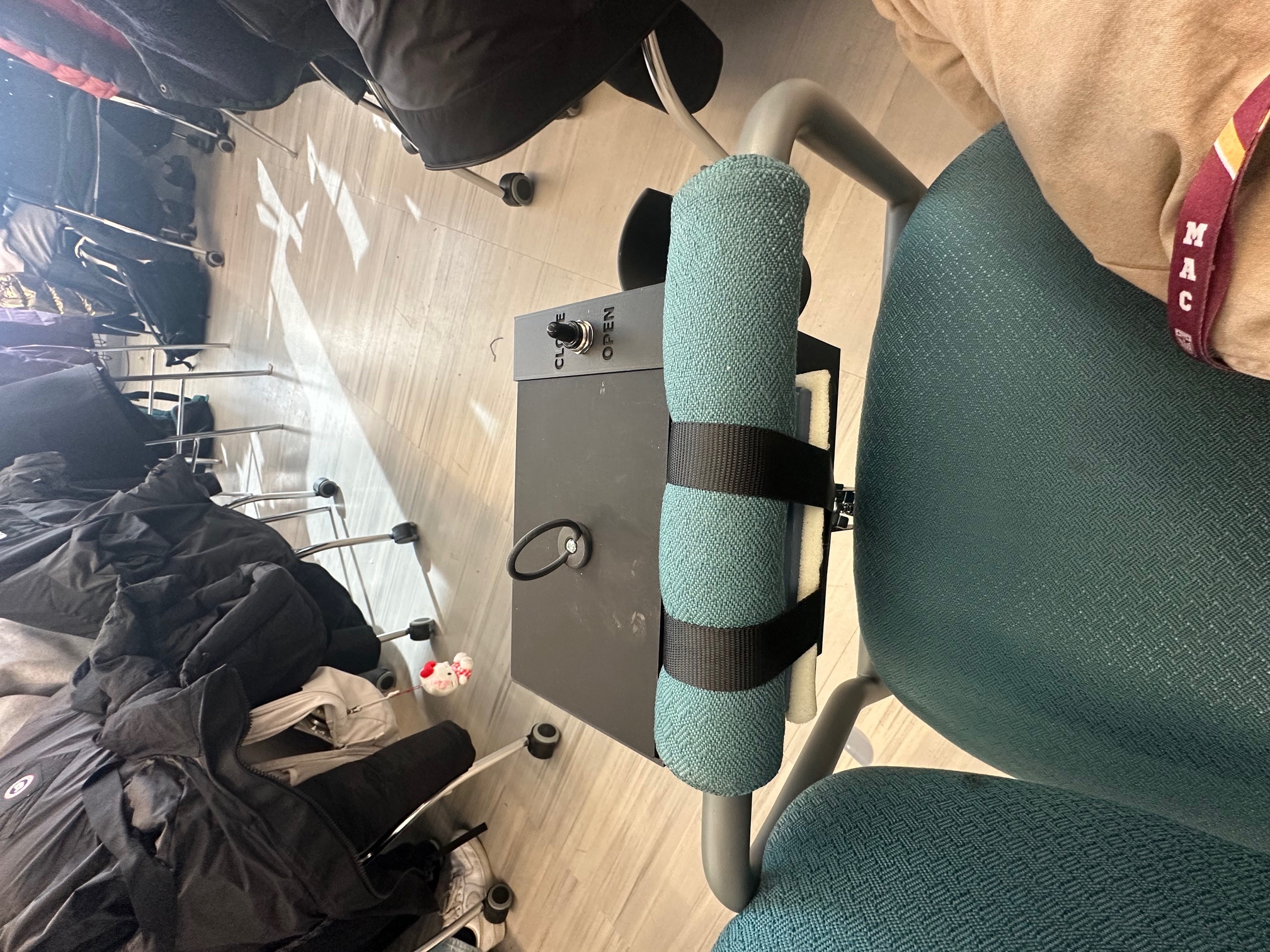 Lift Locker mounted closed on a wheelchair armrest