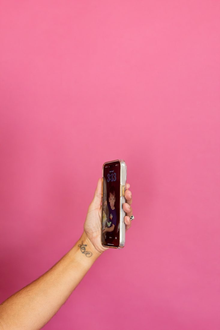 Phone in hand on set at a Flourish content shoot