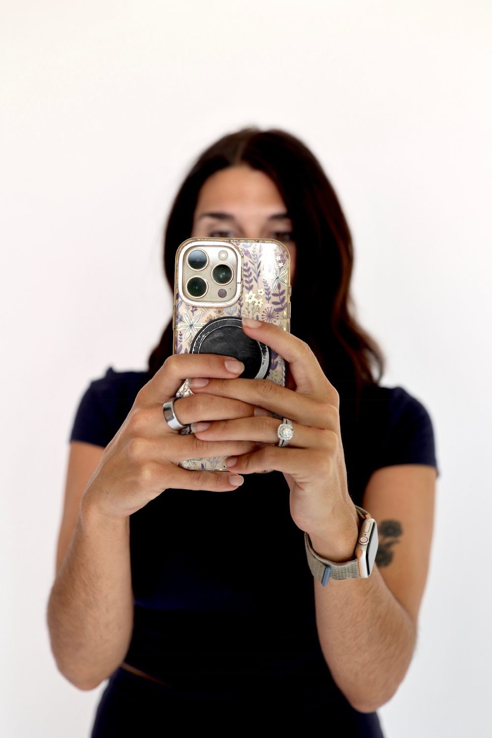 Playfully hiding behind a phone