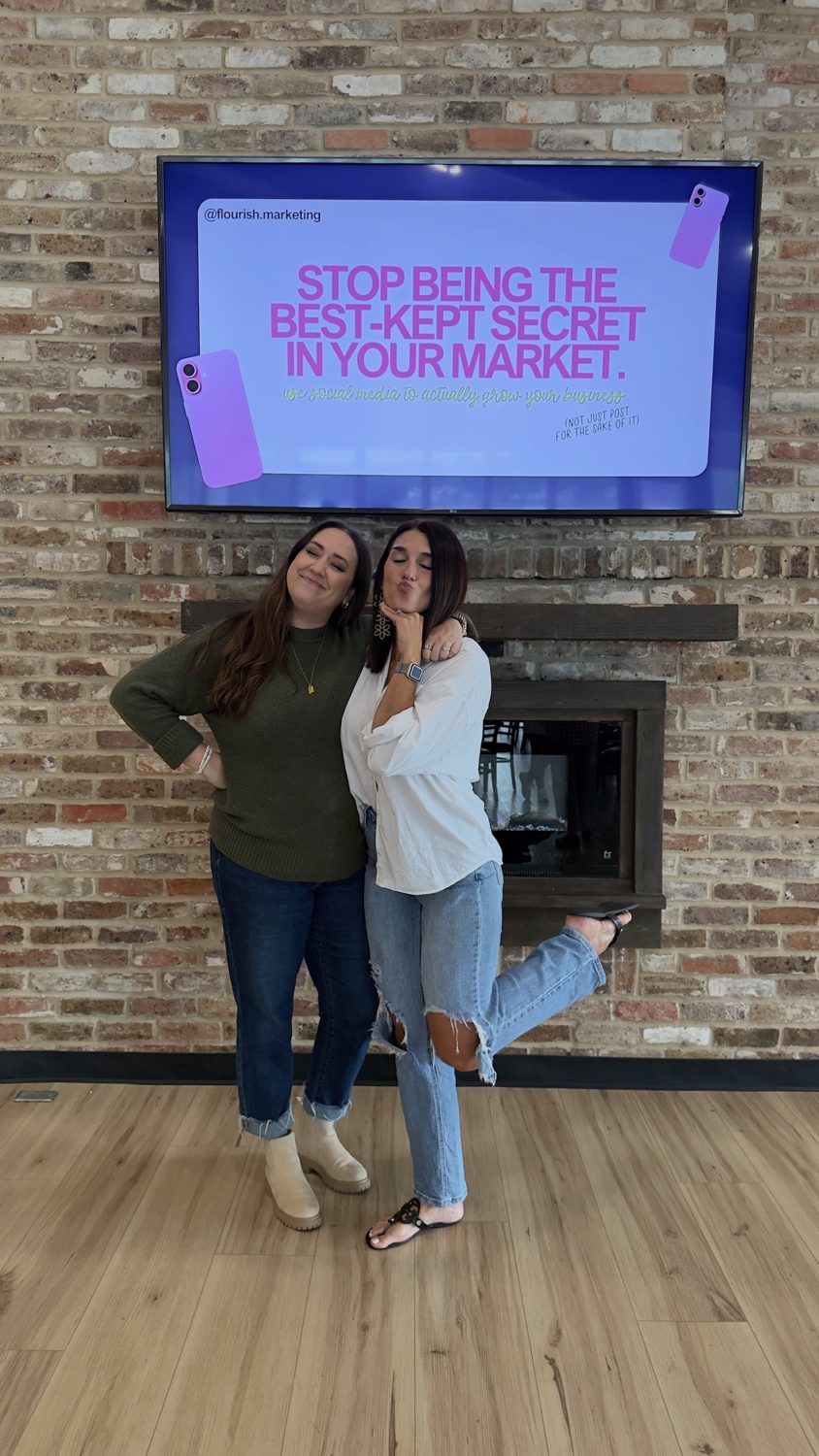 The founders beside client work on a lobby screen