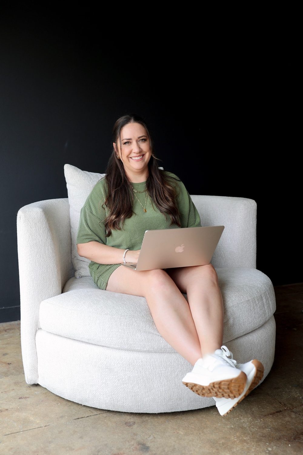 Emily reading on the laptop in the studio chair