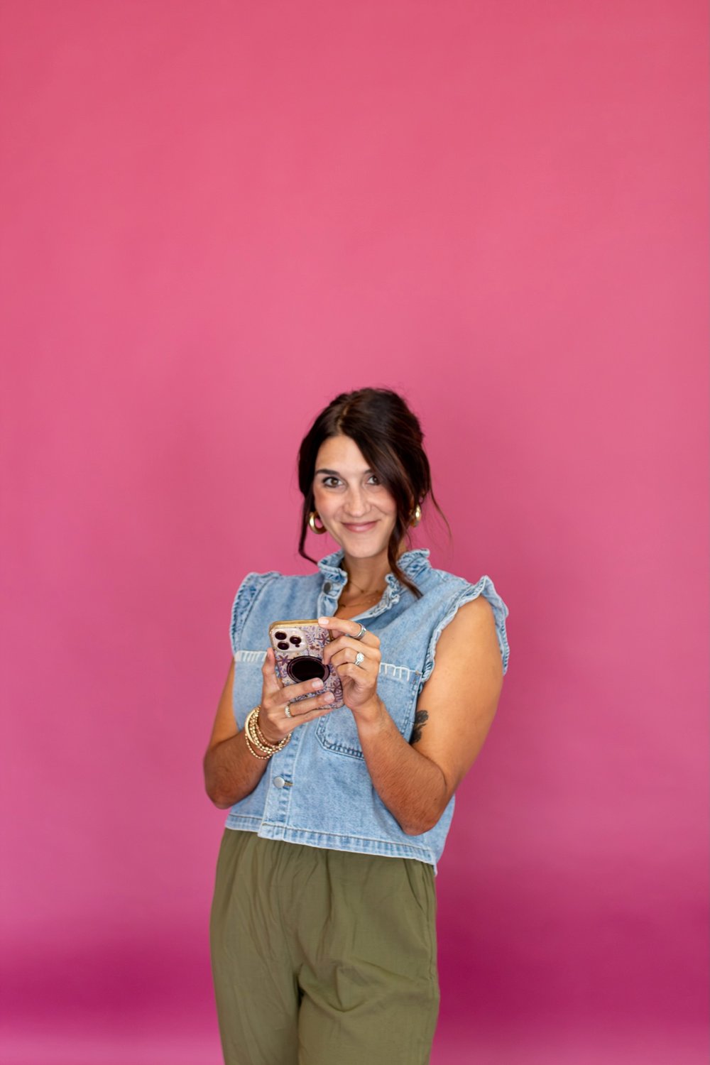 Brenna Barnhill reviewing content on her phone in the Flourish studio