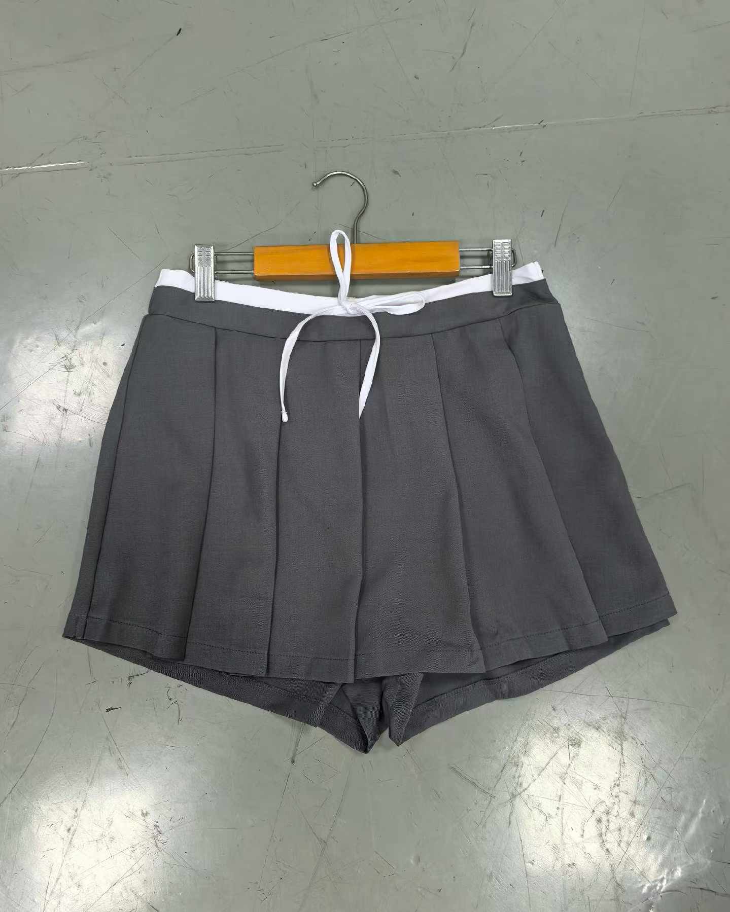 Flat lay display of Ladies' Skort in Grey, Black, Khaki, and Red (Style No. TF9117)