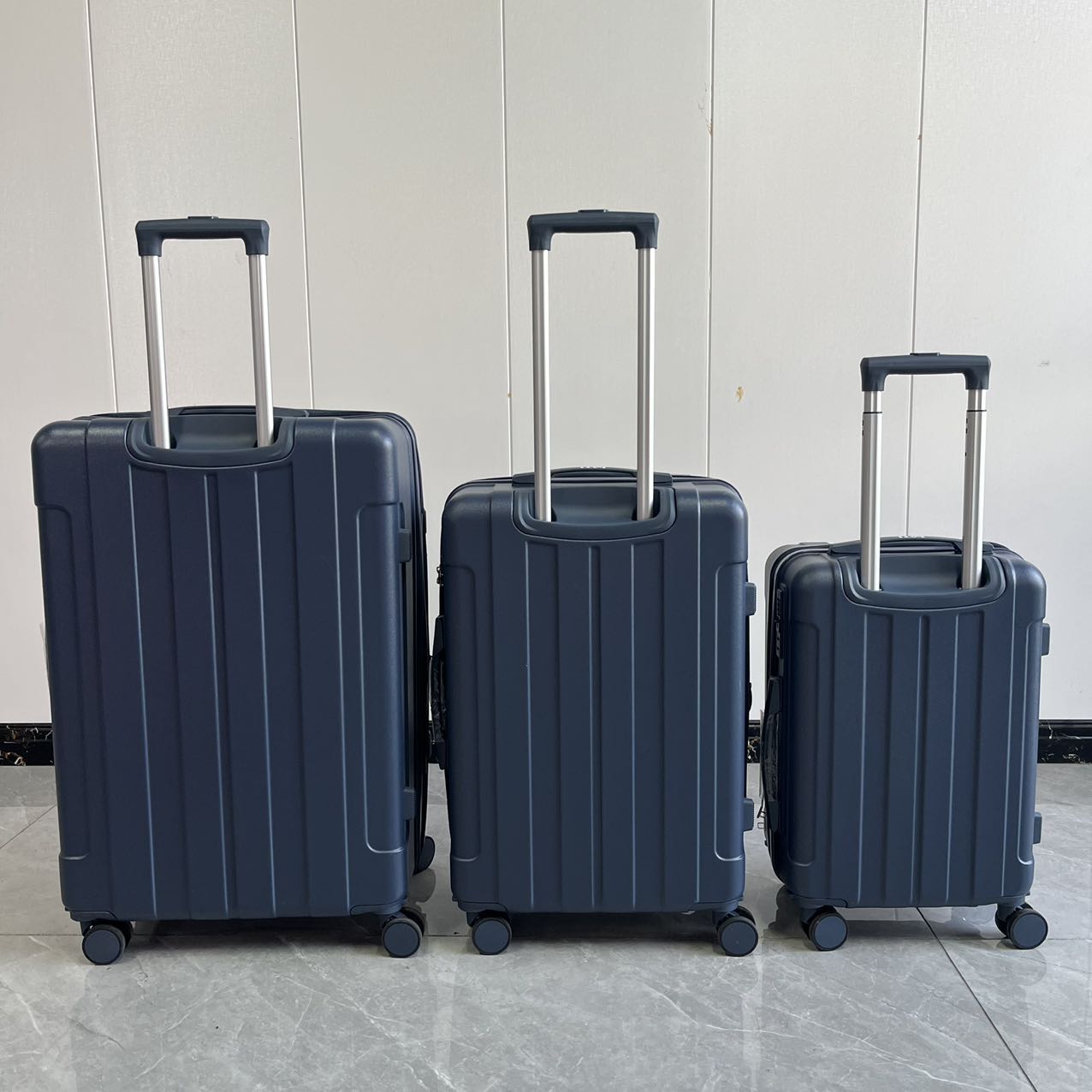 Front view of 3-piece blue hard-shell luggage set