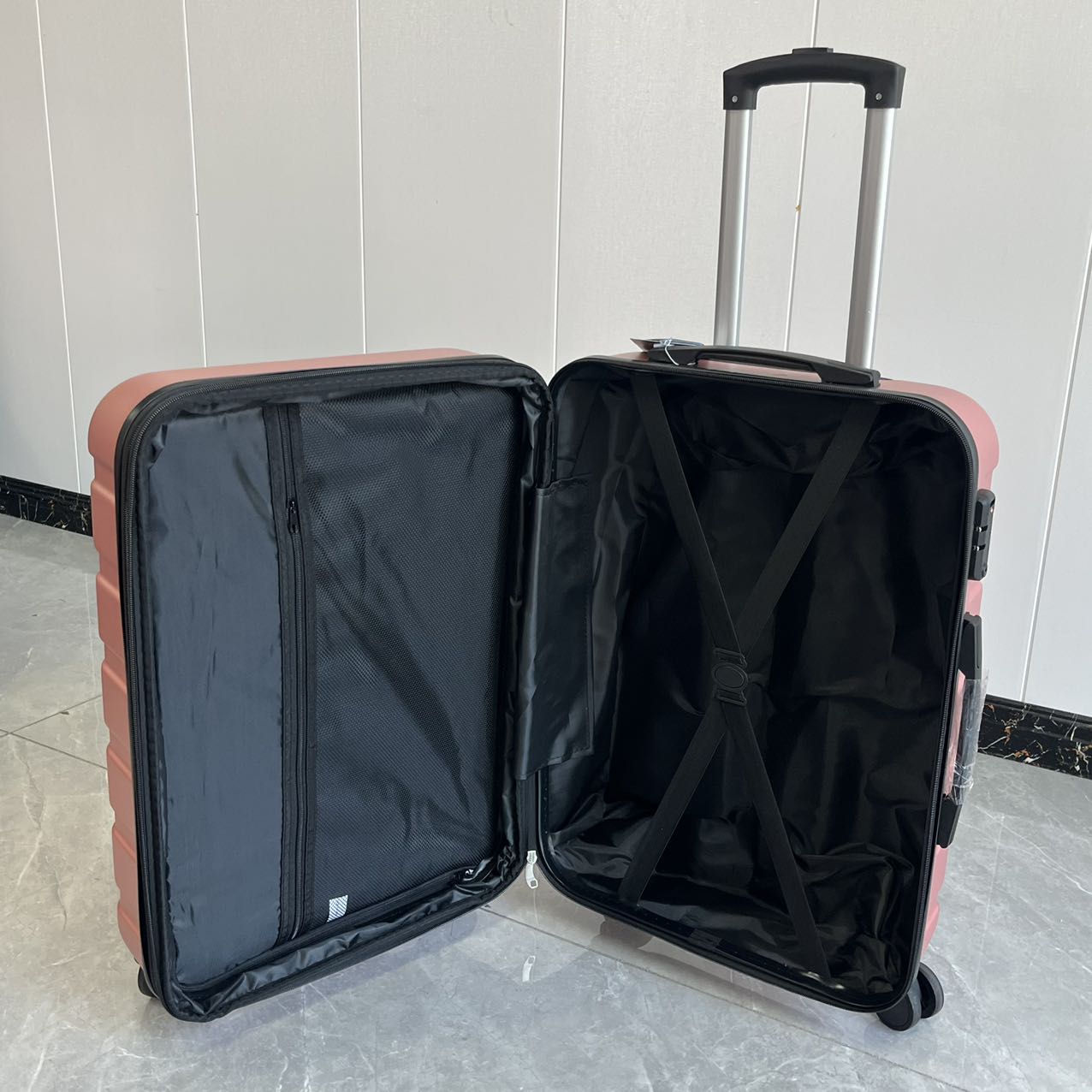 Close-up of rose gold luggage corner showing durable construction