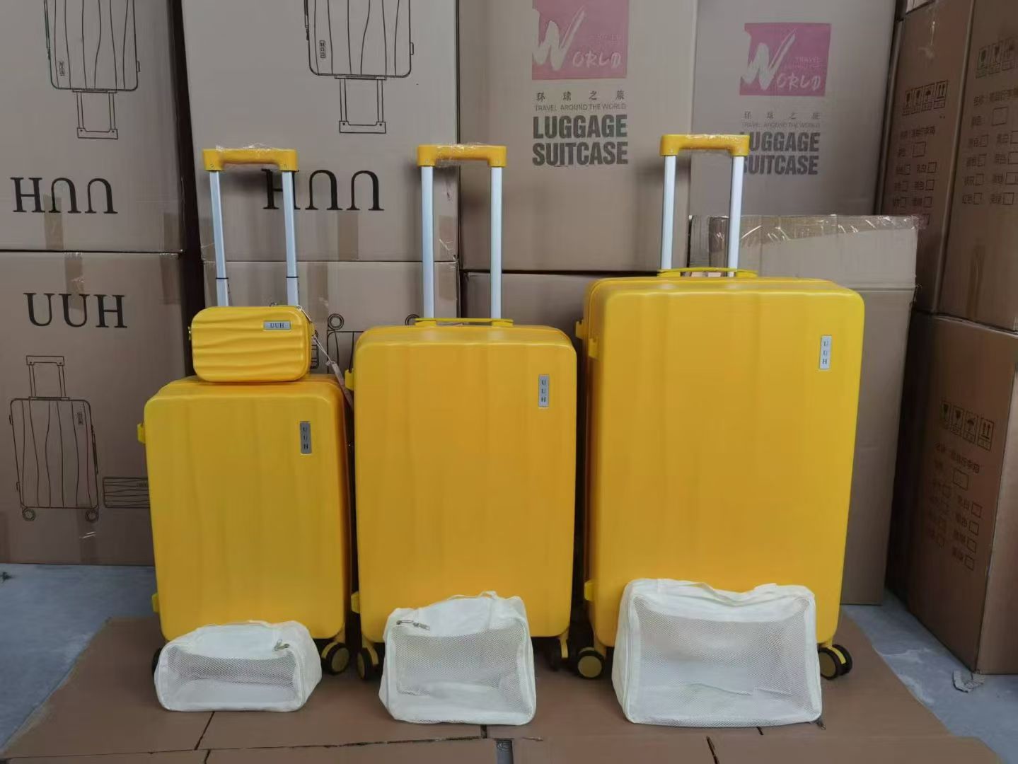 Yellow 7-piece hard-shell trolley suitcase set with vanity cases displayed in a row