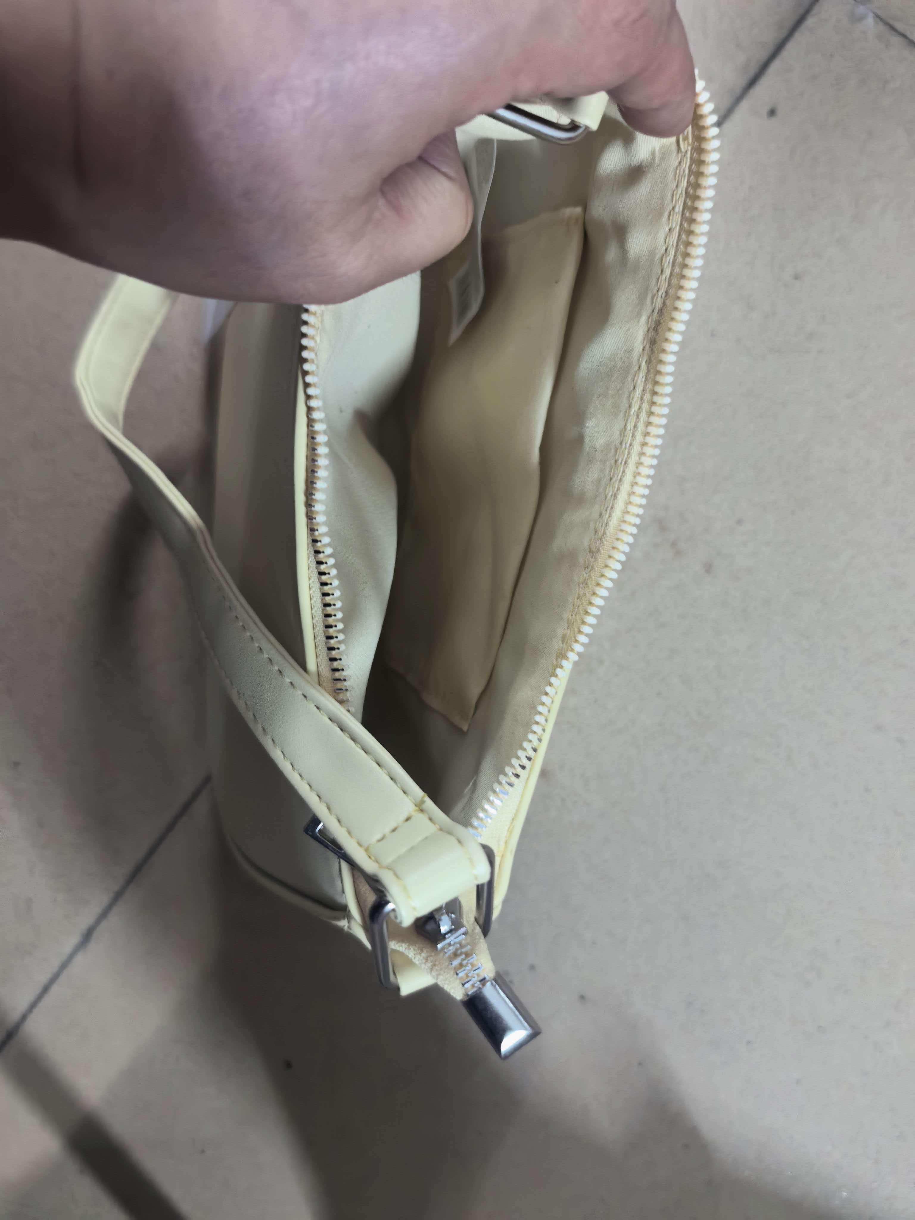 Top view into open cream hobo bag showing interior compartment
