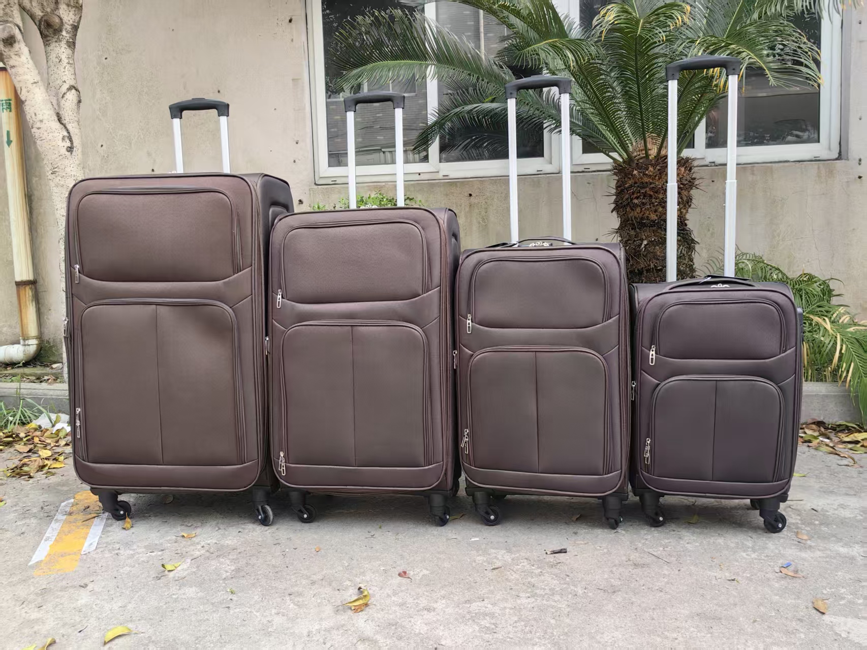Stack of bronze nesting trolley suitcases outdoors