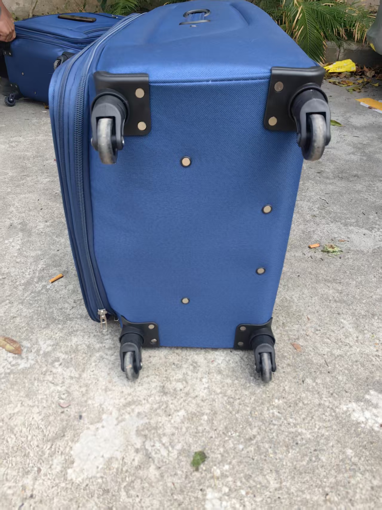 Single blue hard-shell trolley case with wheels