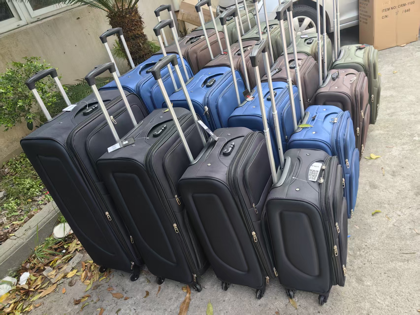 Row of black trolley travel bags with telescopic handles