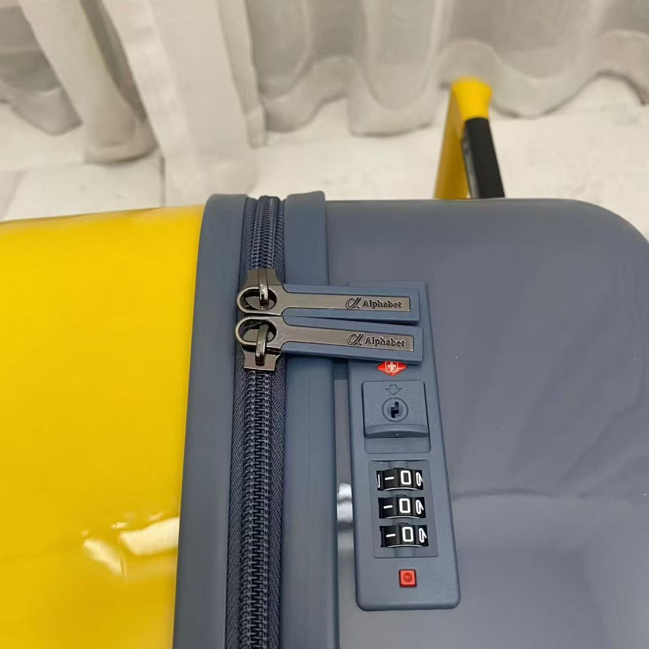 Close-up view of suitcase side combination lock and zipper closure