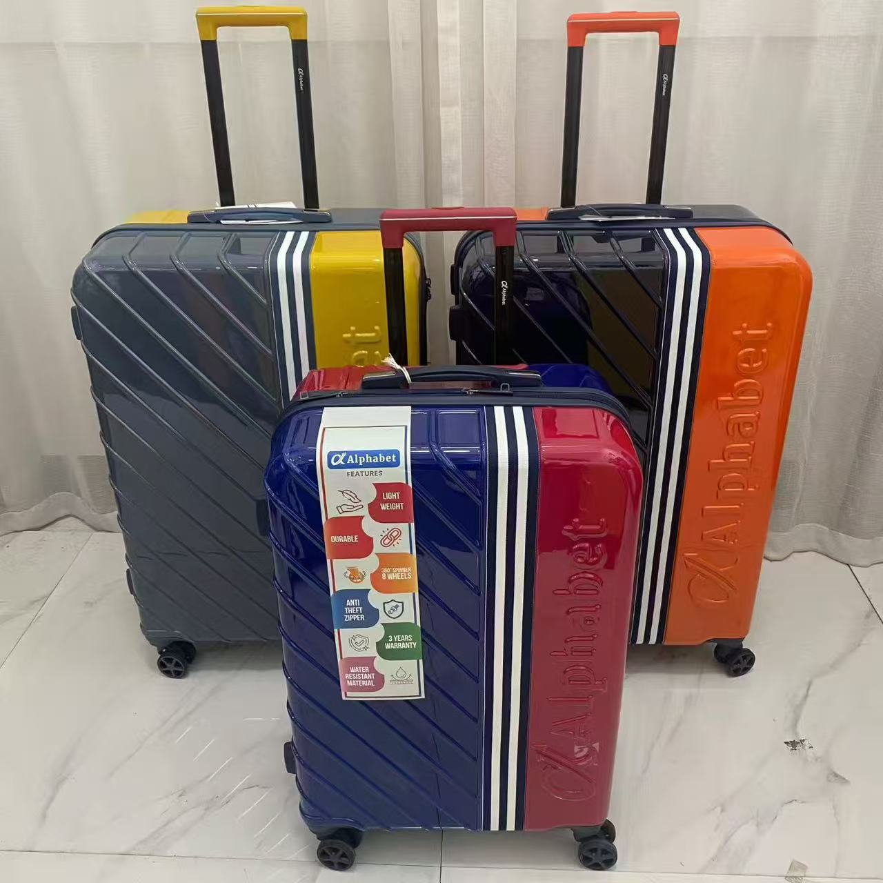 Back view of colorful trolley suitcases showing telescopic handles and side feet