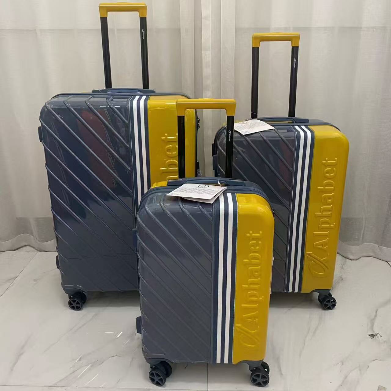 Front view of colorful trolley luggage set in red yellow and orange