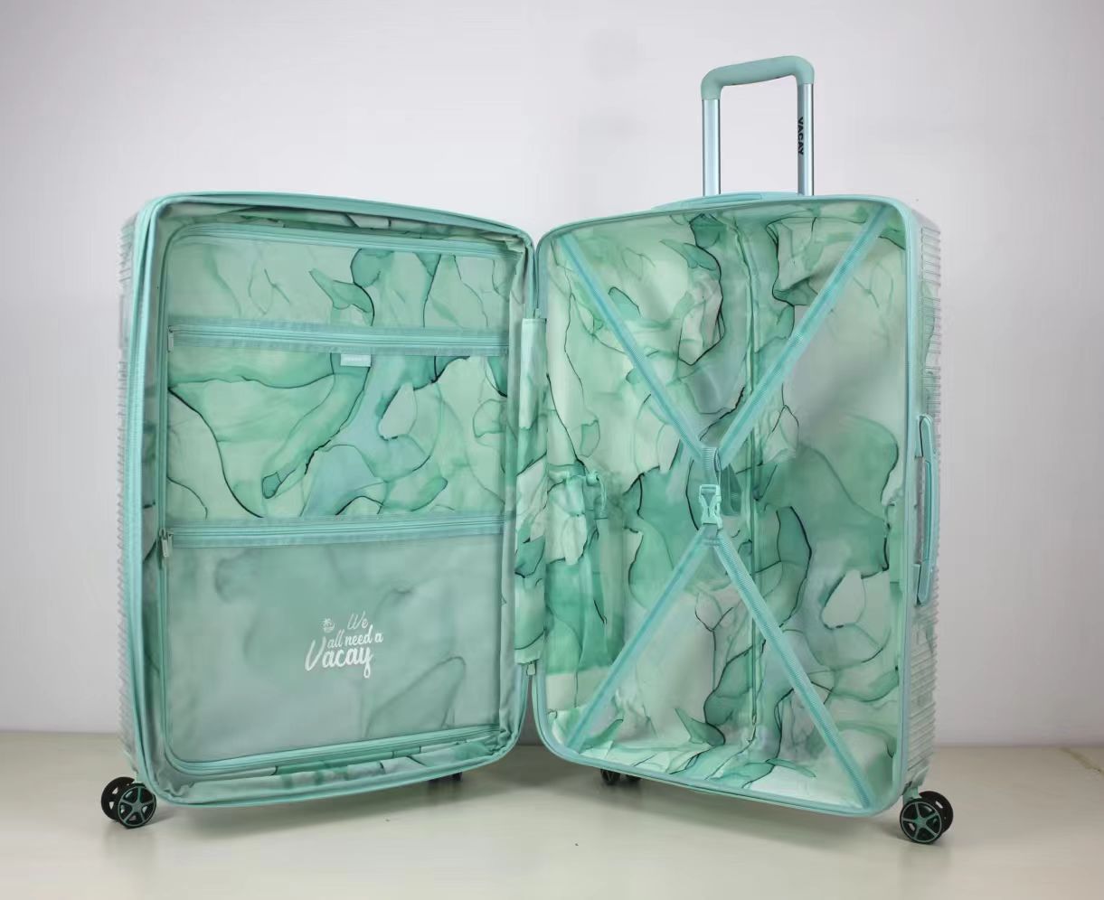 Front view of green patterned 2-piece spinner luggage set