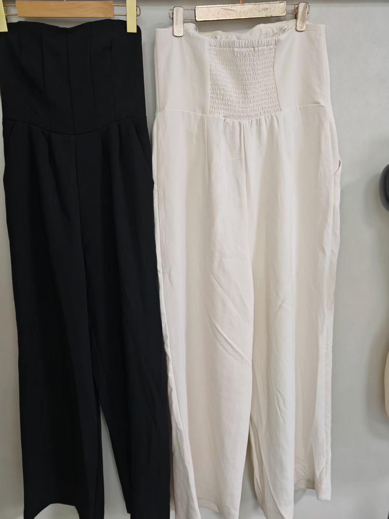 Full length view of off-white and black strapless wide-leg jumpsuits