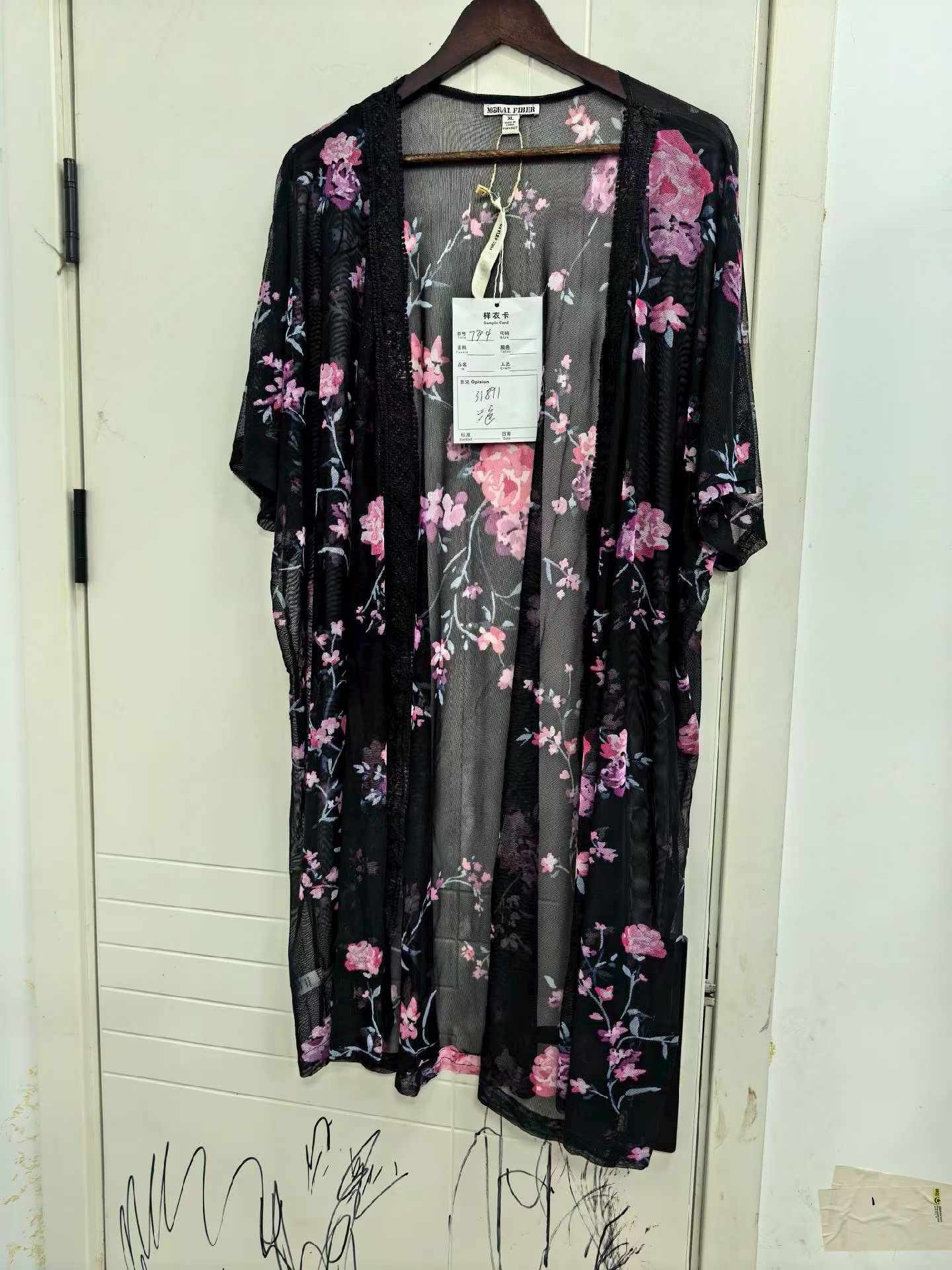 Black floral print ladies' kimono cardigan displayed on a mannequin
