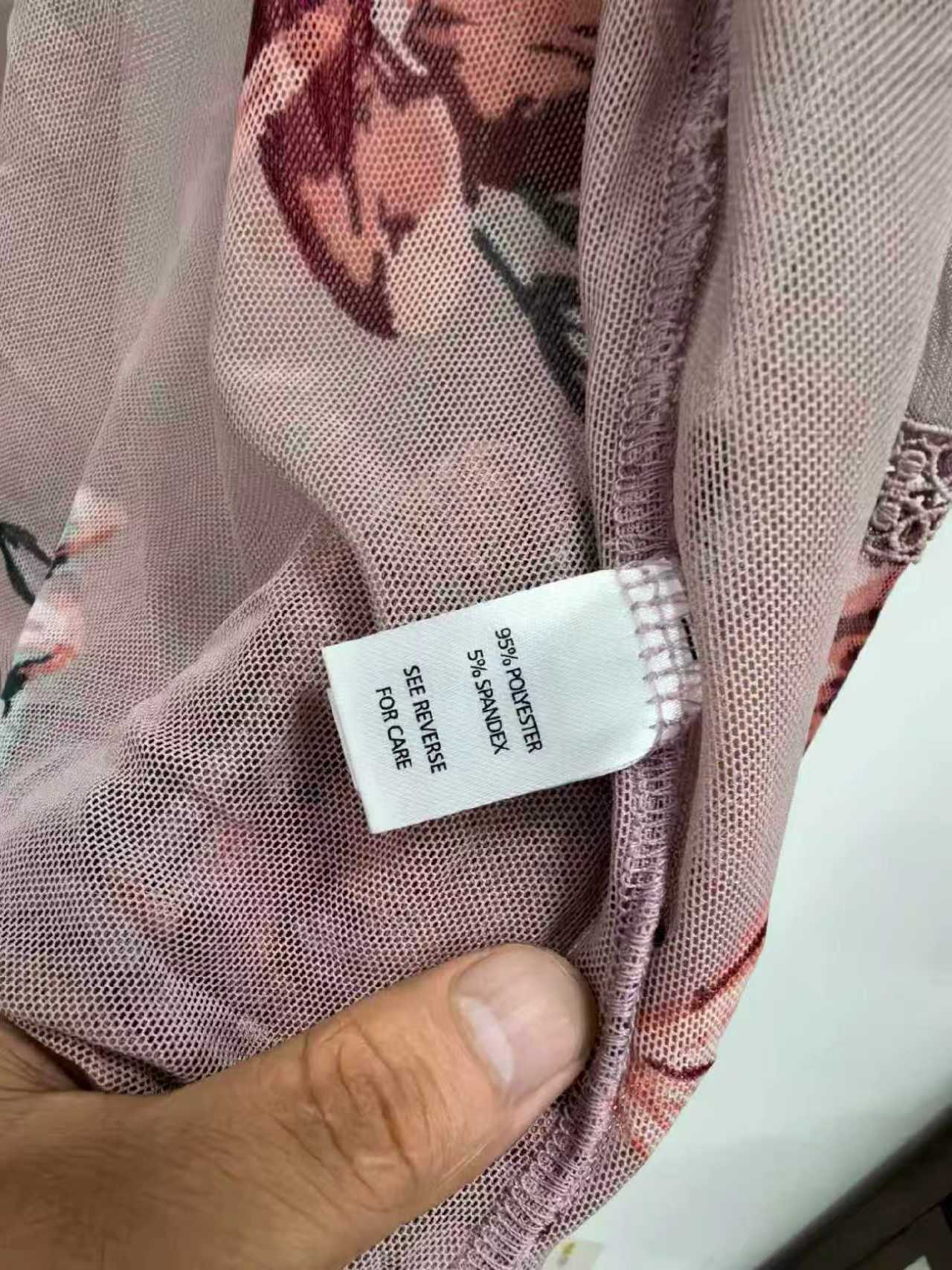 Close-up detail of floral print ladies' kimono fabric and brand label