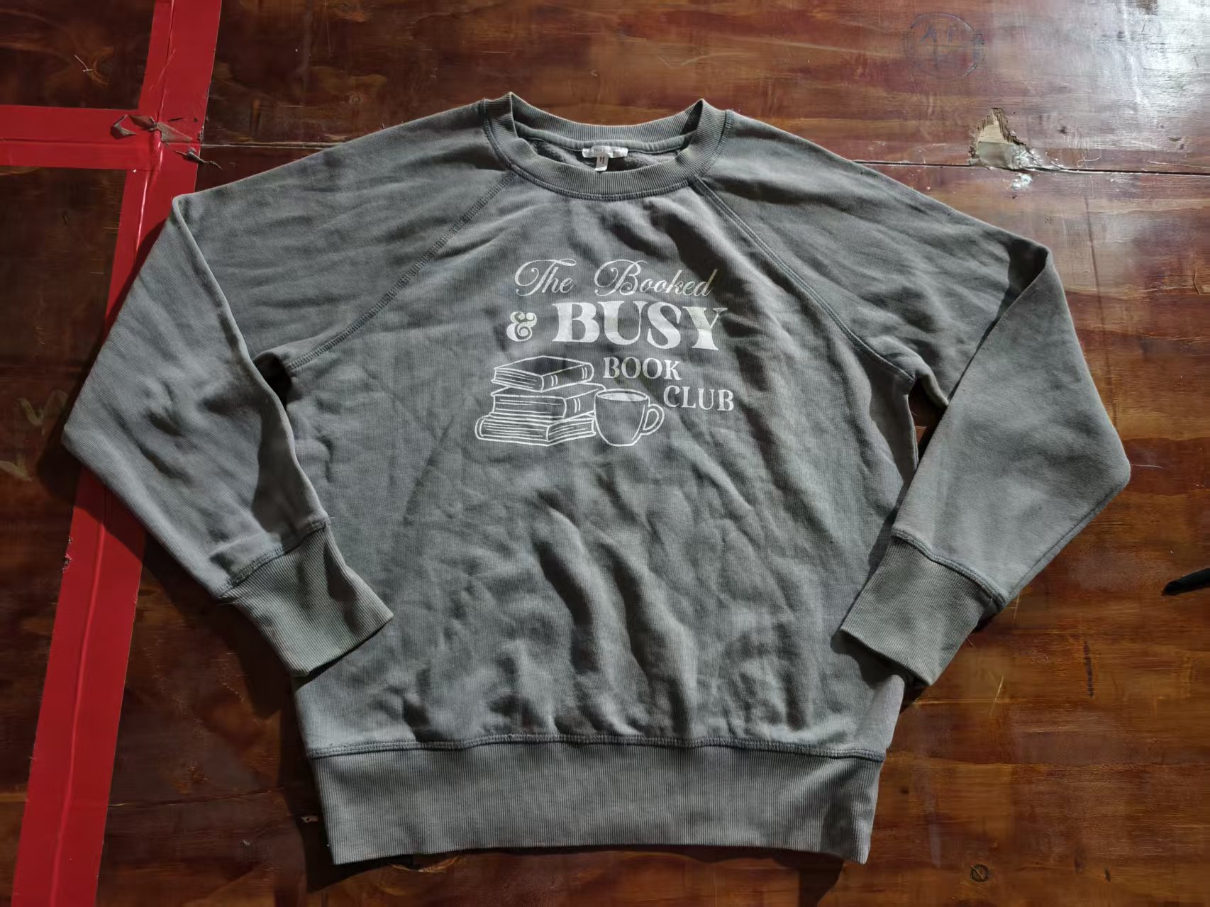 Grey ladies' cotton blend blouse with BUSY text print displayed flat