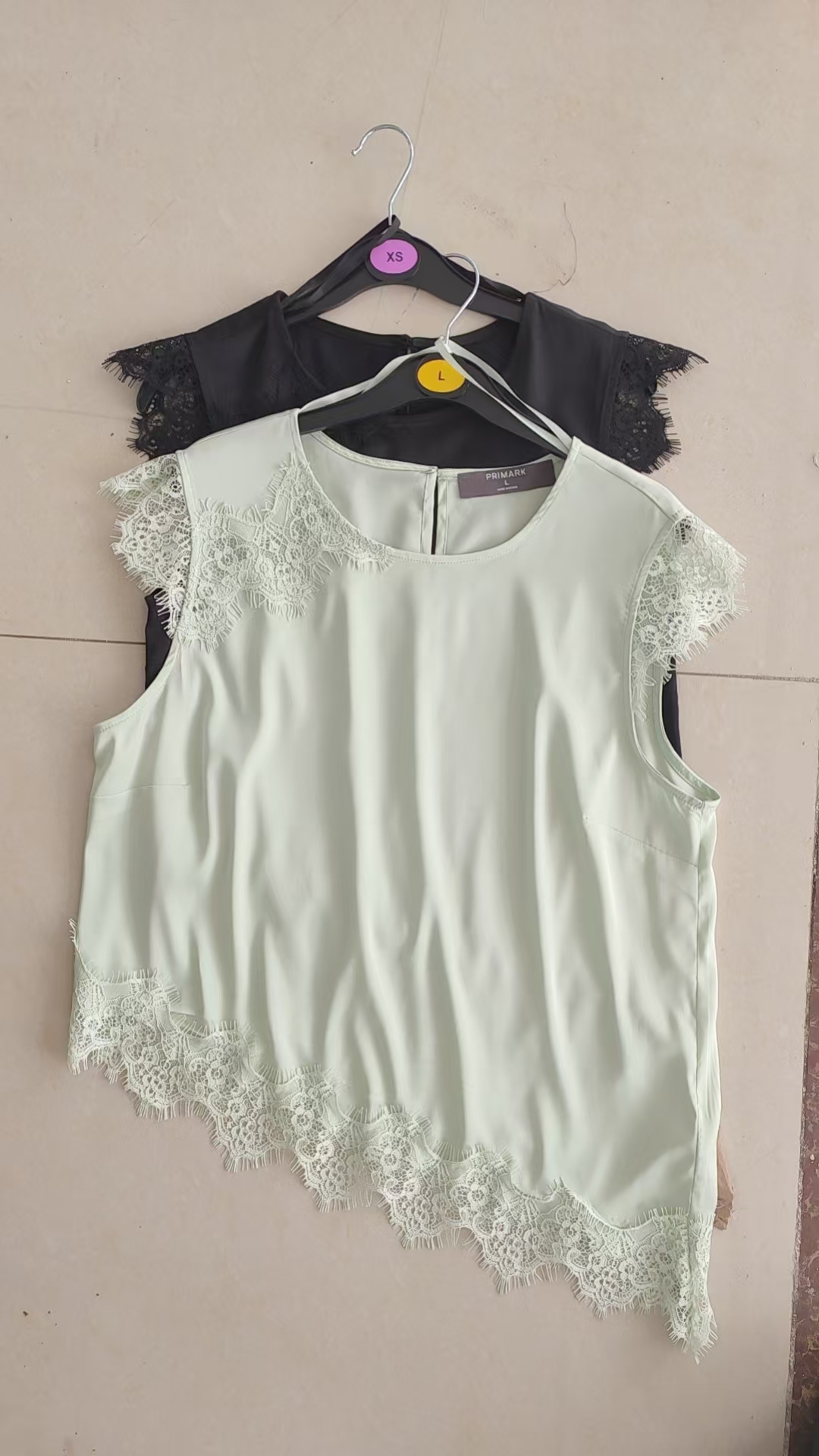 White and black ladies' short sleeve blouses on clothing hangers