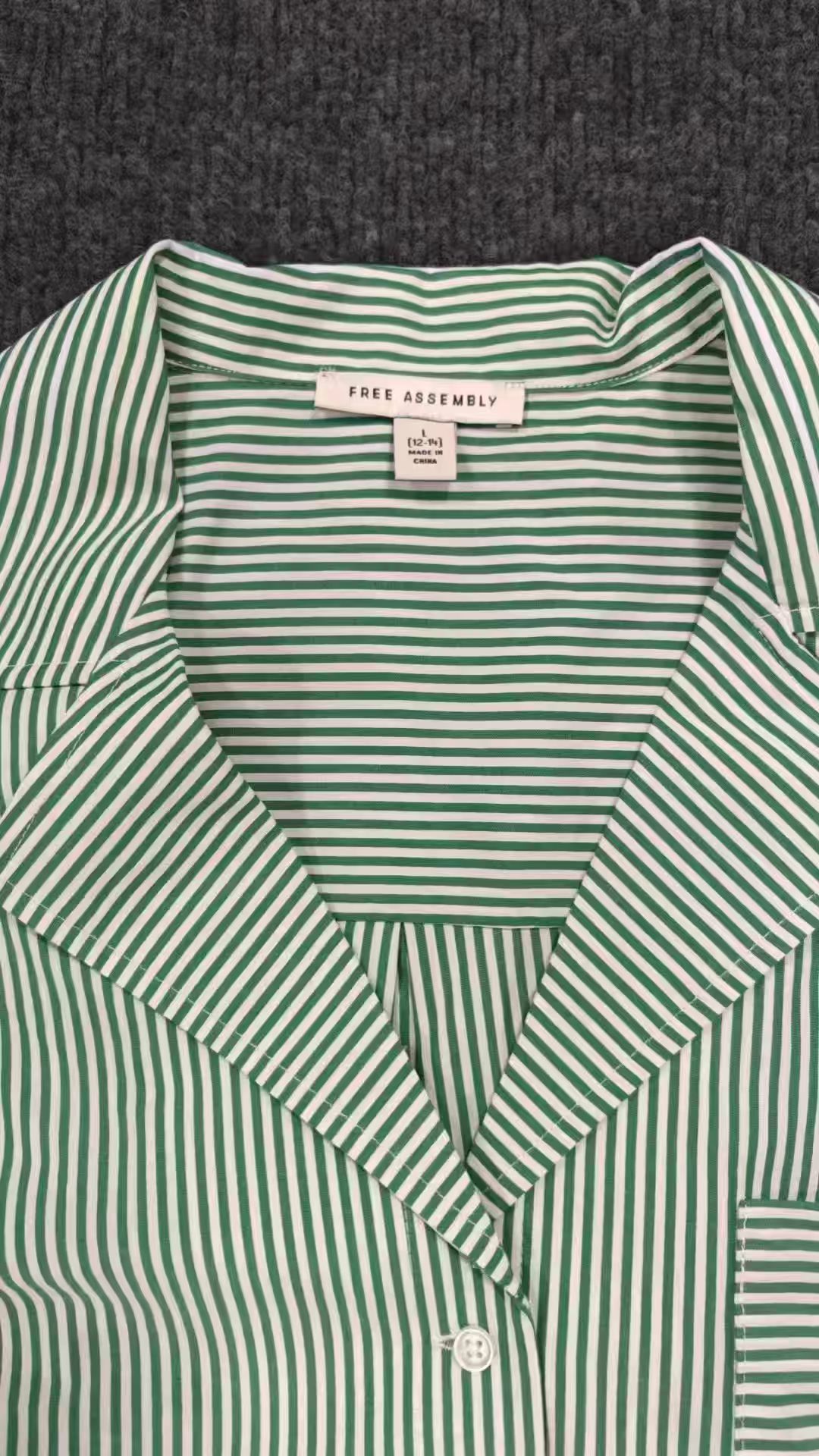 Green striped ladies' short sleeve cotton blouse displayed flat