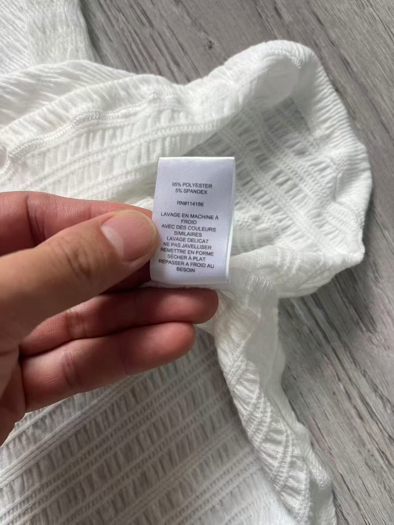 Close-up view of white ladies' blouse collar and neck seam