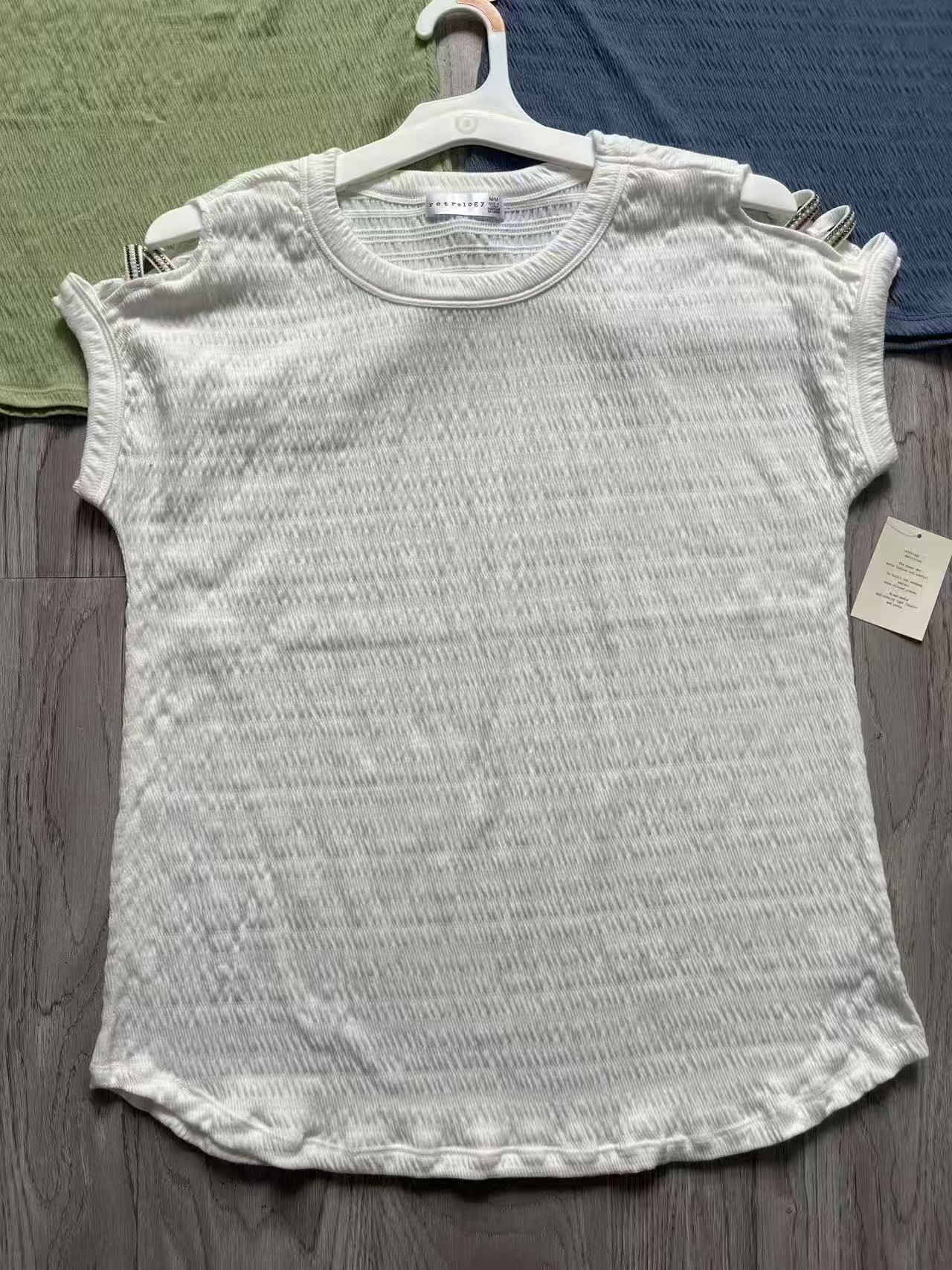 White ladies' short sleeve blouse displayed flat