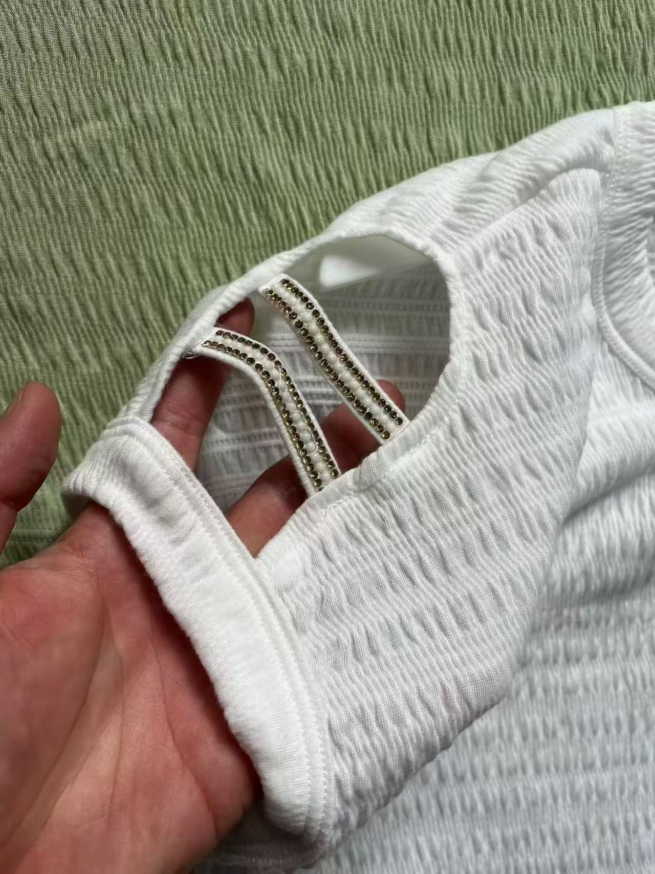 Close-up detail of green ladies' blouse neckline and collar seam
