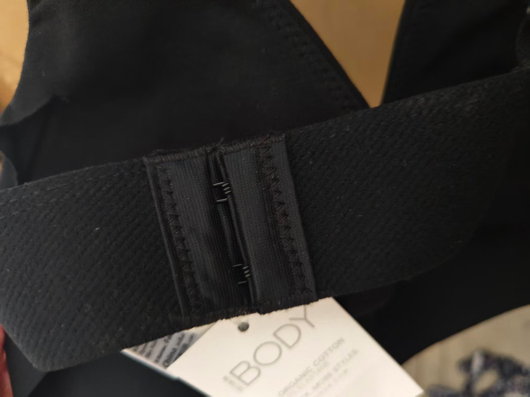 Close-up view of black ladies' bra brand label and care tag