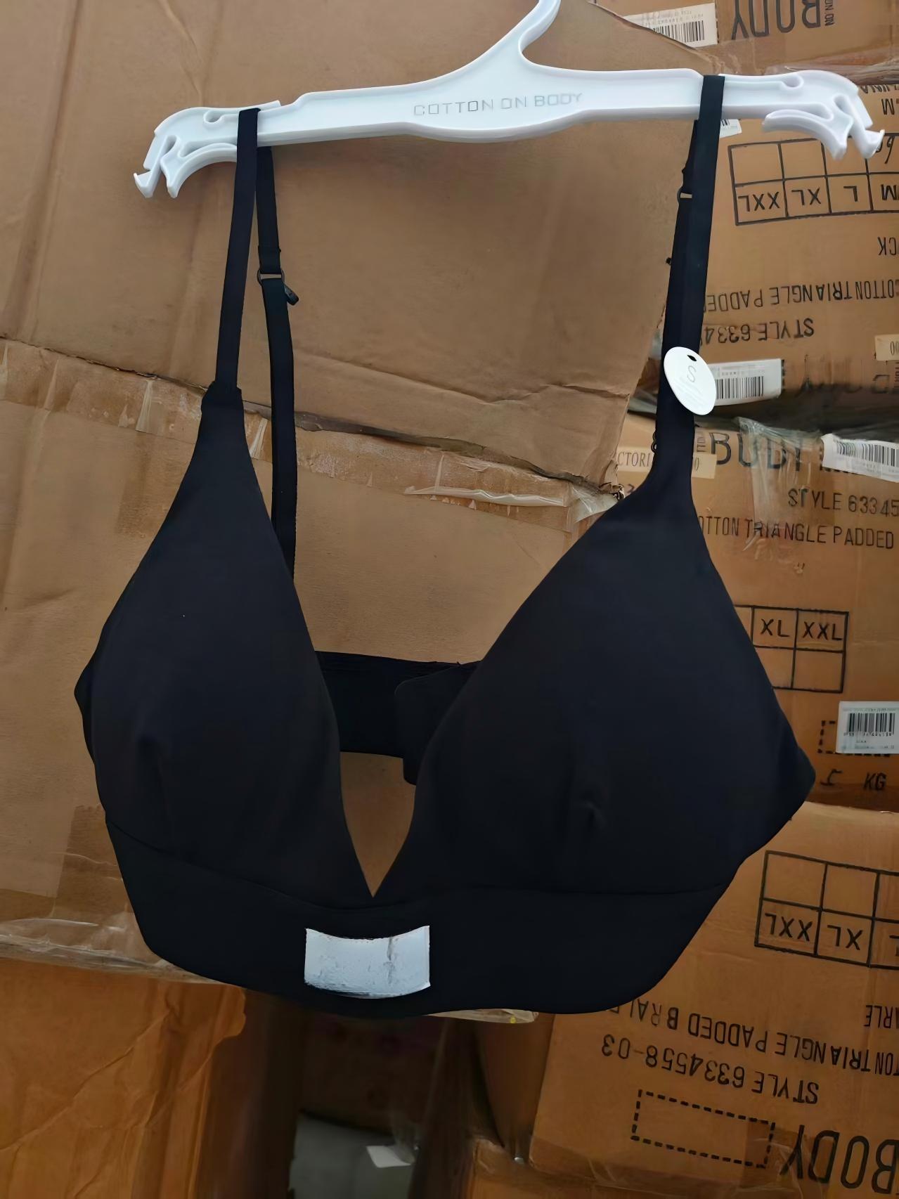 Black organic cotton ladies' bra on clothes hanger displayed on clothing rack