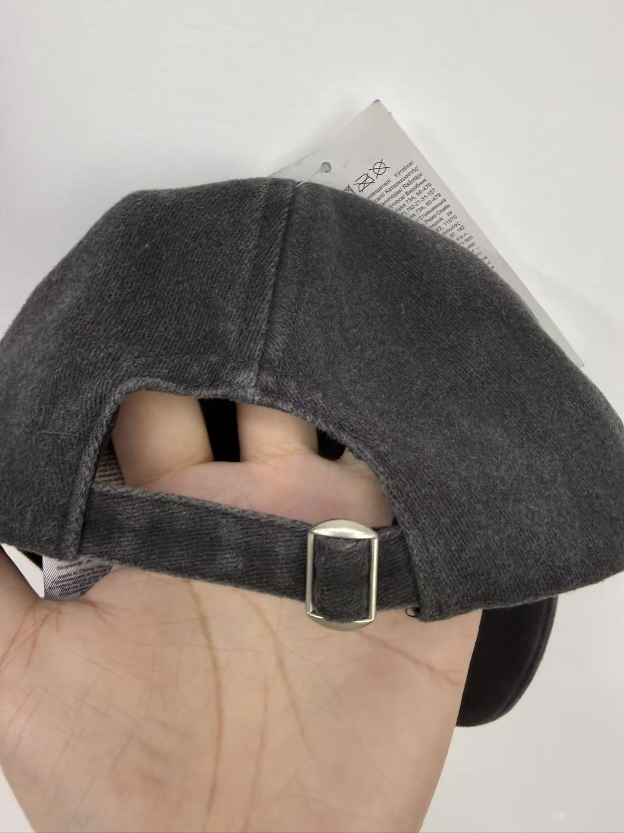 Back view of black boy's baseball cap showing adjustable strap closure on mannequin head