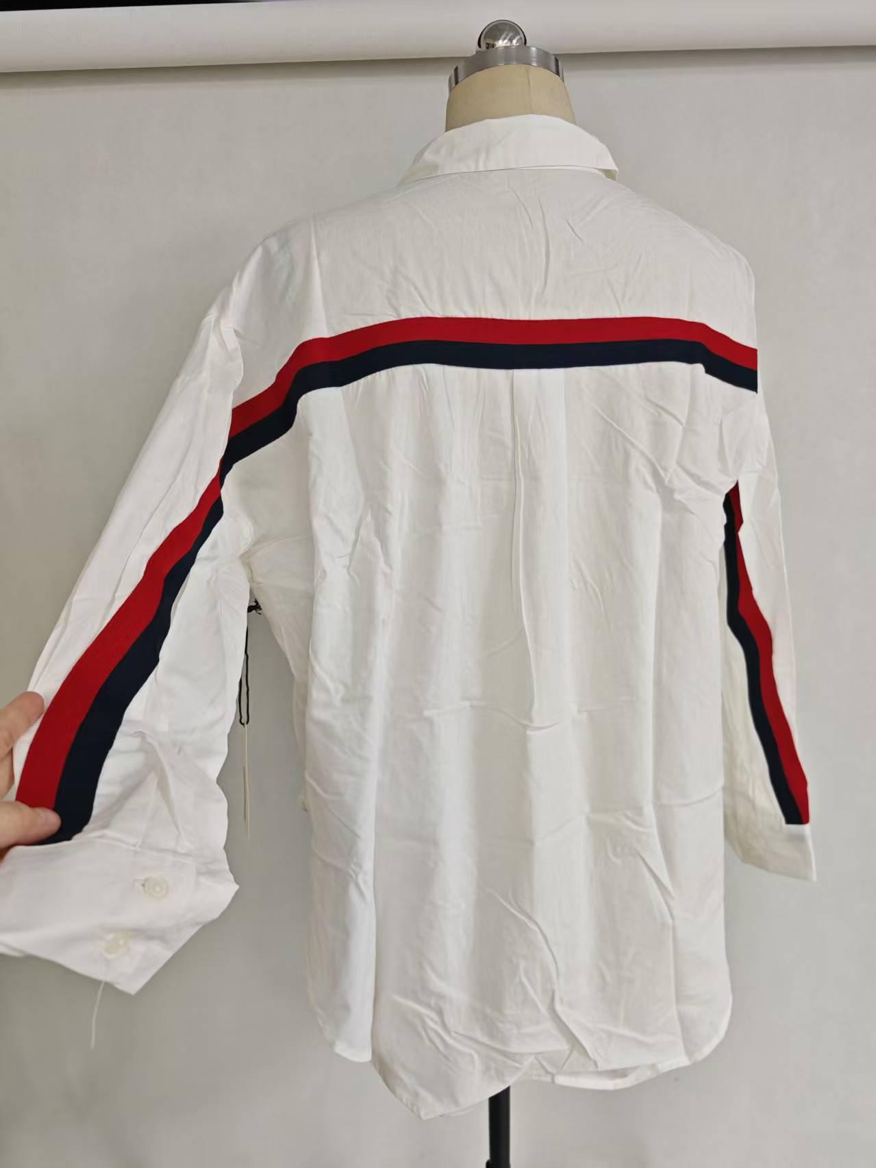 Model wearing white ladies' long sleeve cotton shirt paired with black skirt