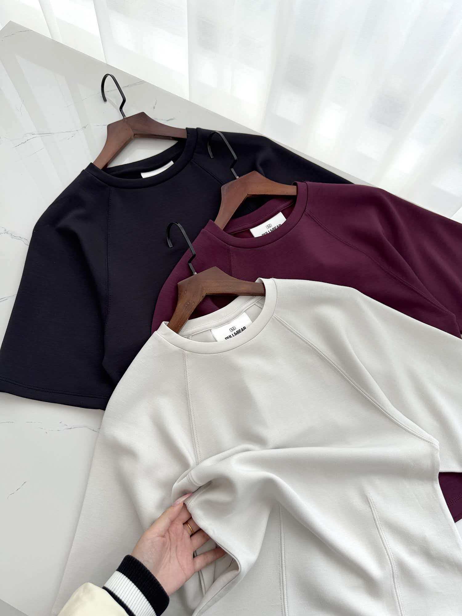 Ladies' short sleeve t-shirts displayed together on clothing hangers