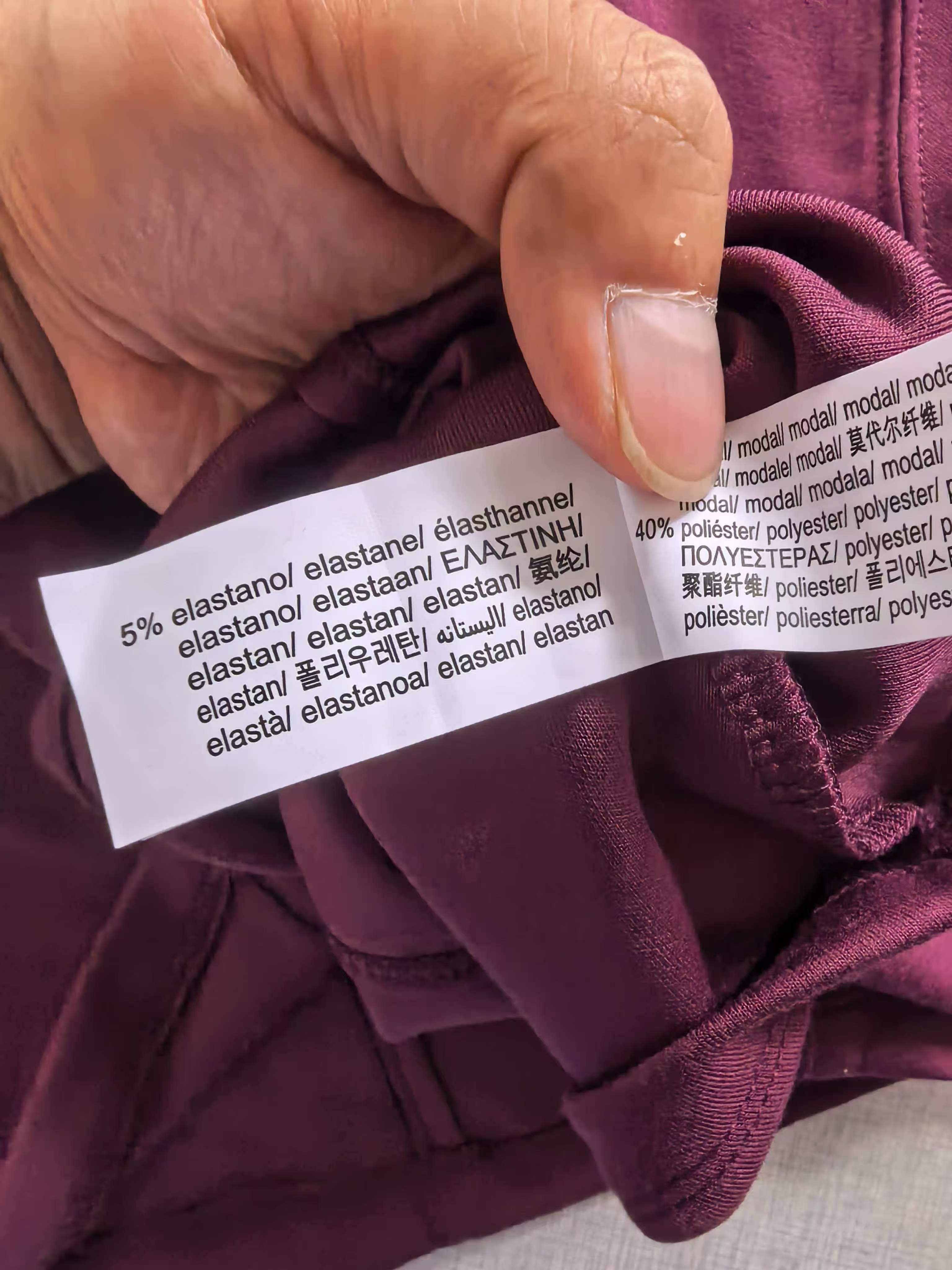 Close-up detail of burgundy ladies' t-shirt neck label and fabric seam