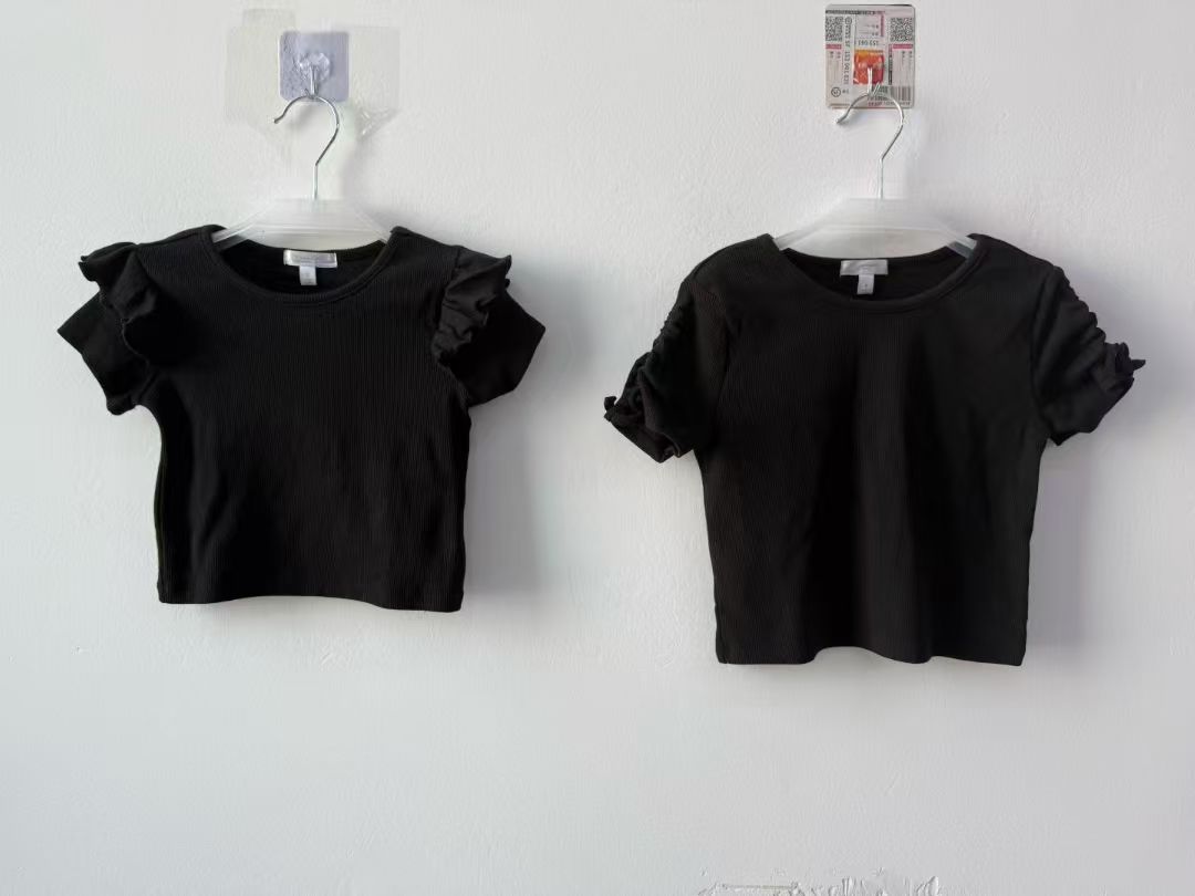 Girl's short sleeve t-shirts in beige and off-white displayed flat