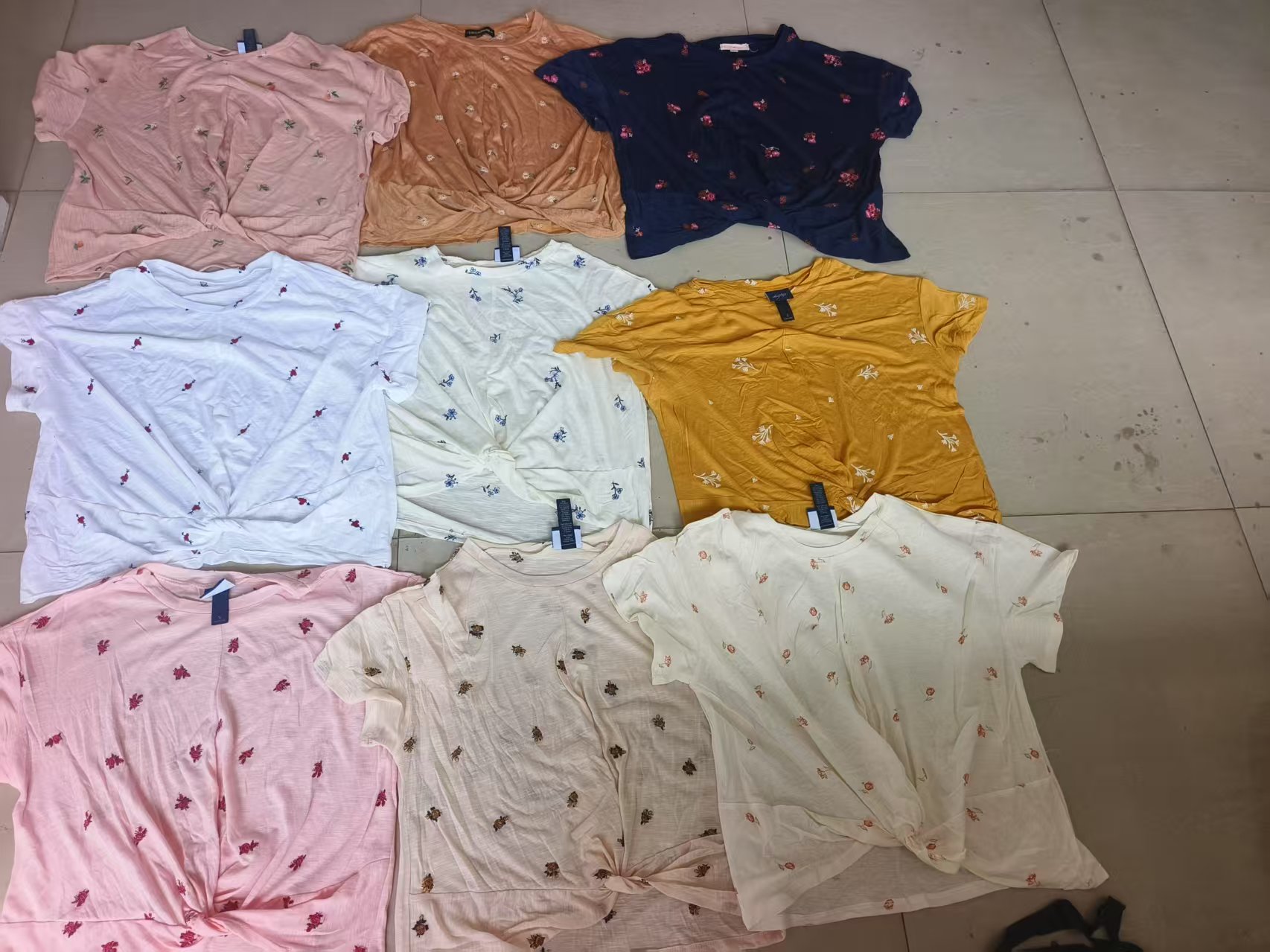 Ladies' short sleeve t-shirts in multiple colors stacked together flat