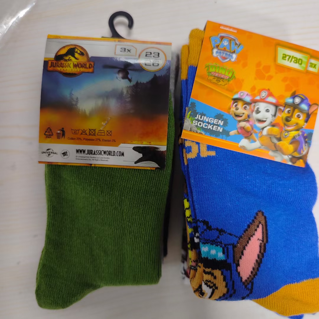 Bright blue and orange kids' socks displayed flat with packaging label
