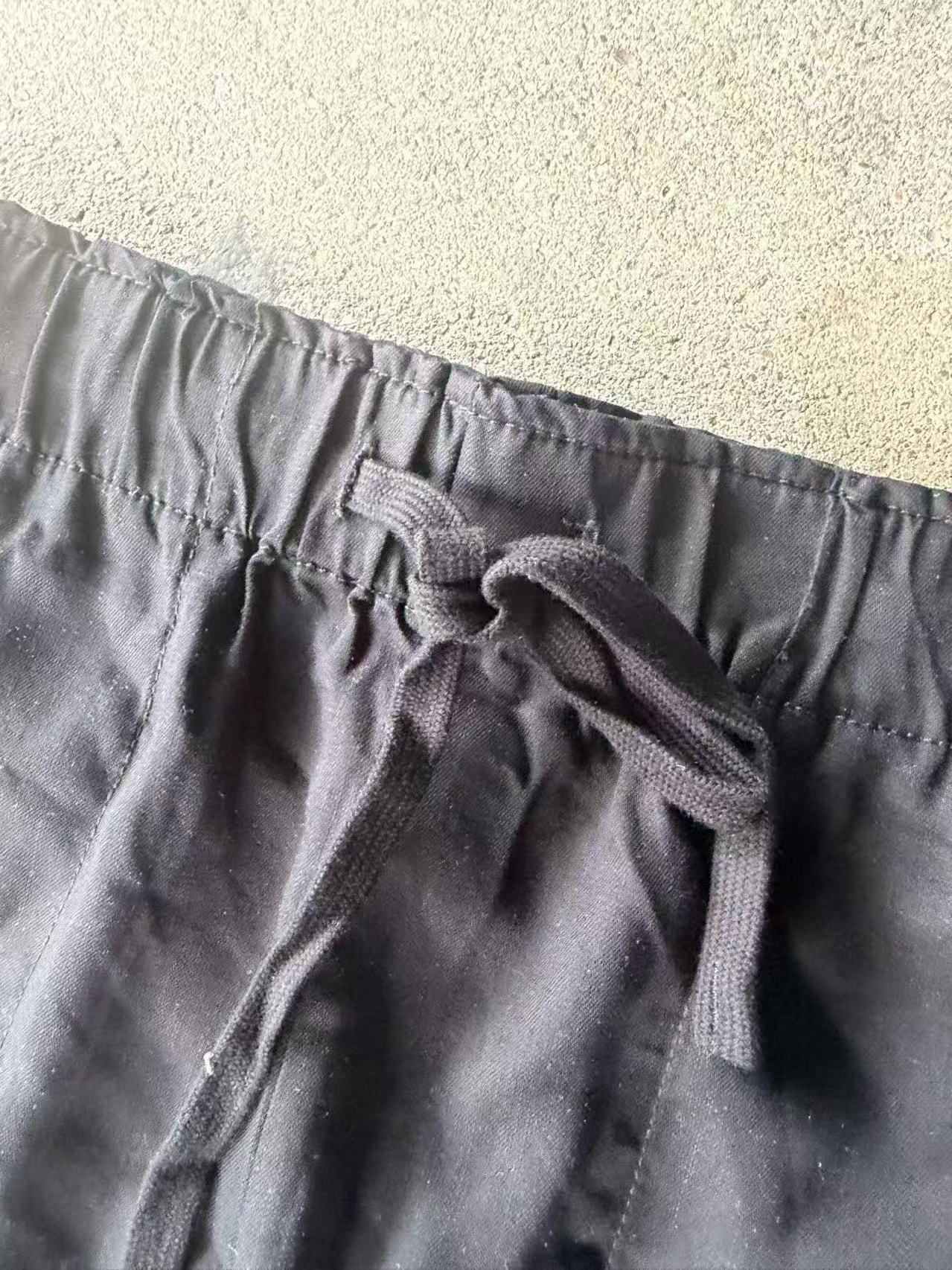 Close-up of the off-white women's Tencel shorts showcasing the leg hem and fabric sheen.