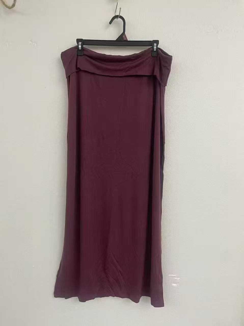 Women's long midi skirt in plum wine red displayed on a torso mannequin.