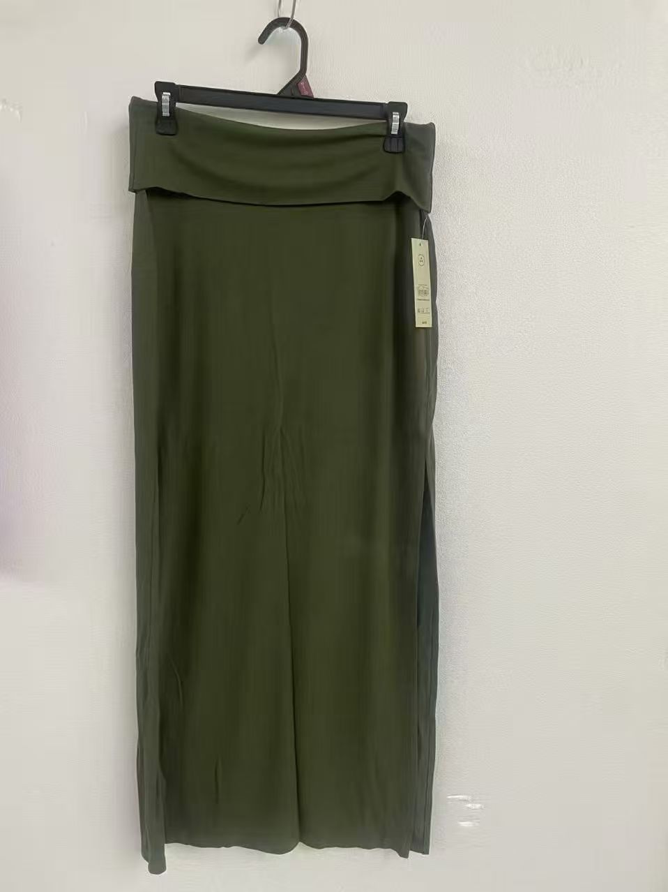 Olive green women's long midi skirt displayed on a torso mannequin.