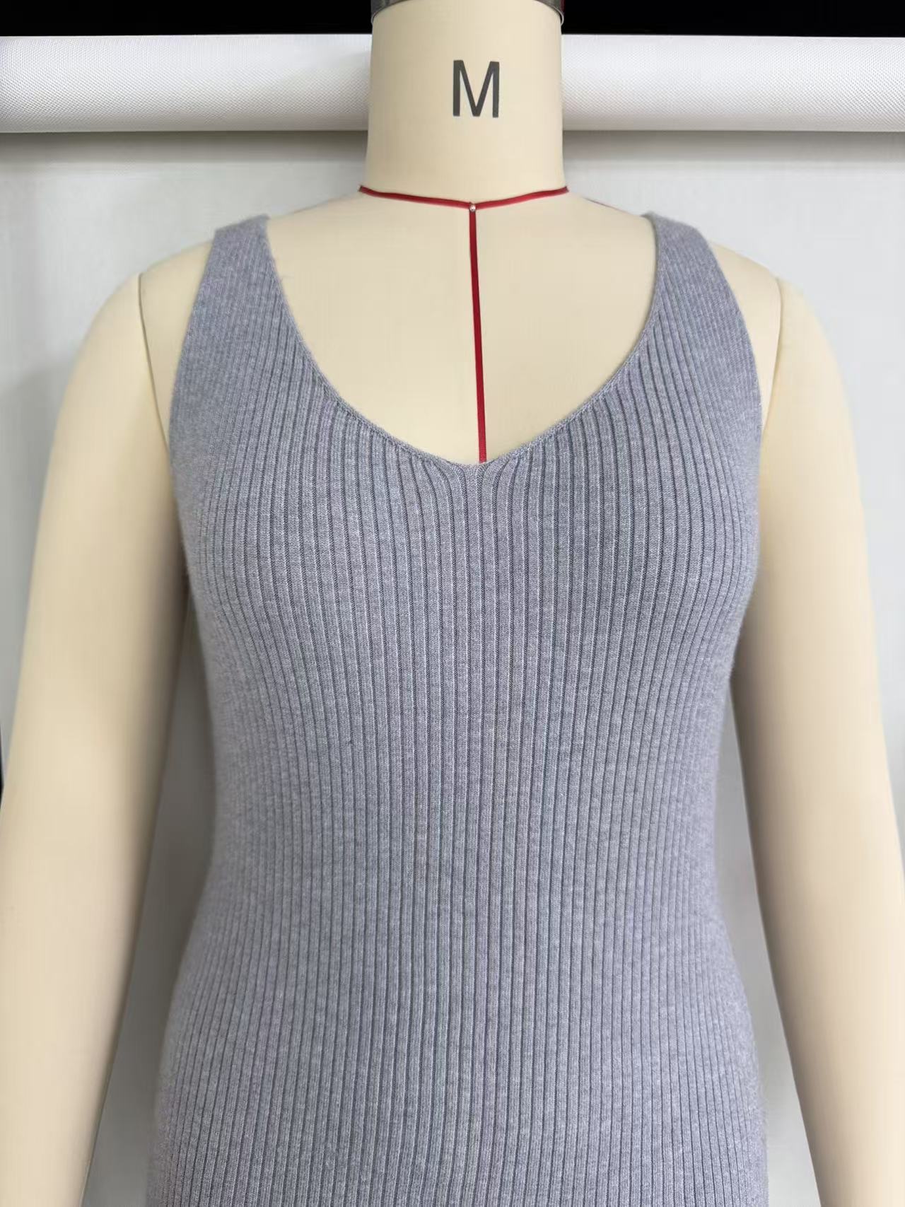 Beige women's ribbed knit short-sleeve midi dress with crew neck displayed on a torso mannequin.