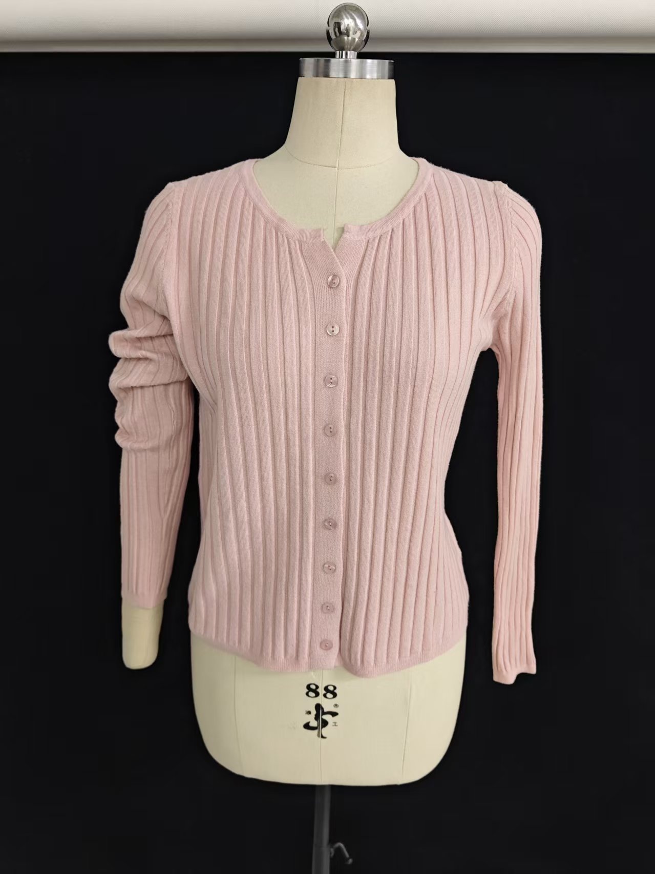 Women's V-neck button-front cardigan sweater in black displayed on a torso mannequin.