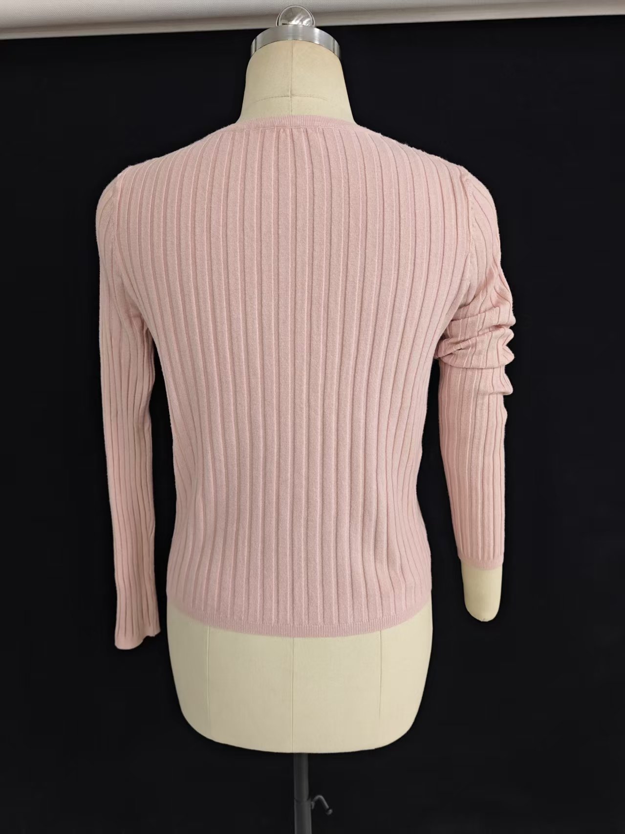 Front view of light yellow women's V-neck button-front cardigan sweater laid flat.