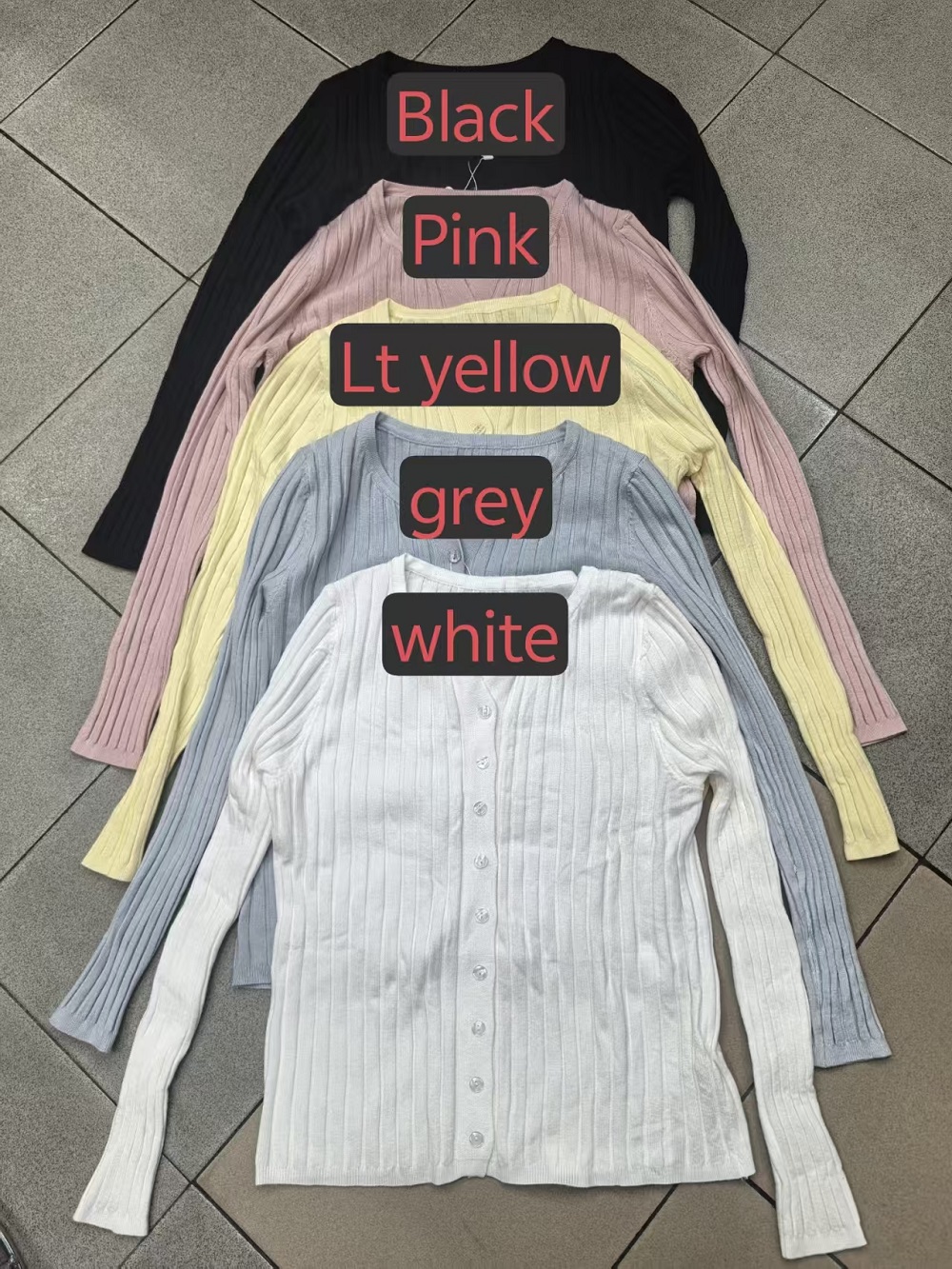 Women's V-neck cardigan sweaters in black, pink, light yellow, grey, and white stacked together.