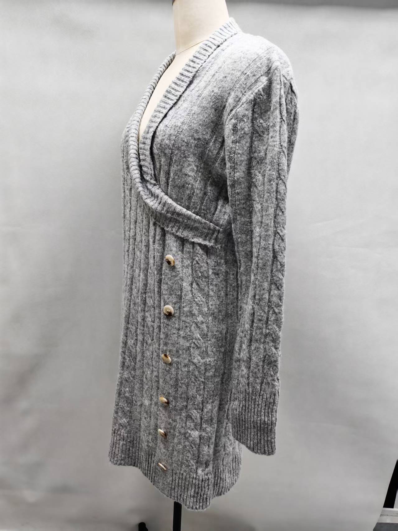 Close-up shot of the grey women's cardigan sweater highlighting the knit fabric texture, front opening, and collar seam.